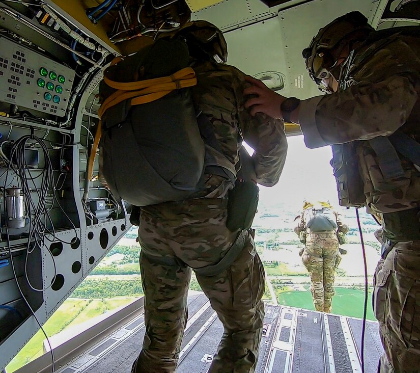 U.S. Air Force Airmen leap from the back ramp of a Pennsylvania Army National Guard CH-47 Chinook helicopter during airborne training May 18, 2022, at Fort Indiantown Gap, Pa. The Airmen were from the 14th Air Support Operations Squadron and 148th ASOS.