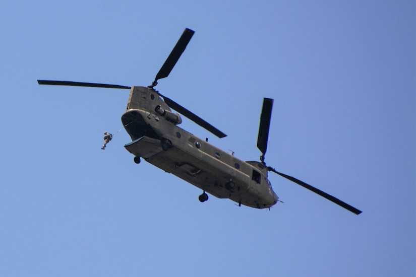 An Airmen from the 14th Air Support Operations Squadron jumps from a Pennsylvania Army National Guard CH-47 Chinook during airborne operations at Fort Indiantown Gap, Pa. The pilots and crew chiefs of the chinook worked to provide the Airmen with a stable platform as they moved over the drop area.