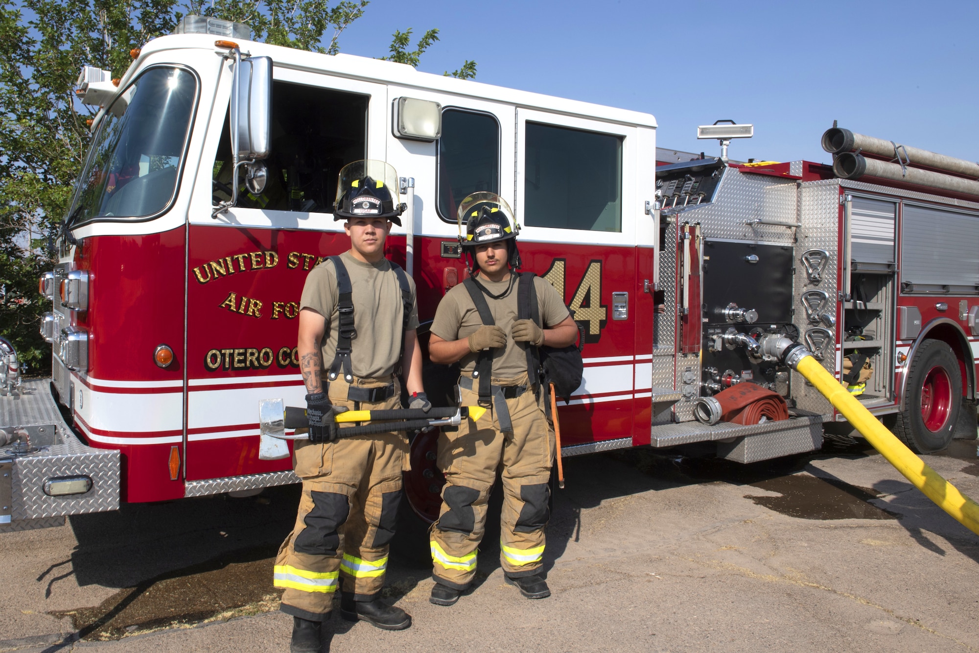 Airman 1st Class Jayden Zepeda (left) and Airman 1st Class Kevin Gomez (right), 49th Civil Engineer Squadron firefighters, pose for a photo after an emergency response training exercise, May 19, 2022, on Holloman Air Force Base, New Mexico.