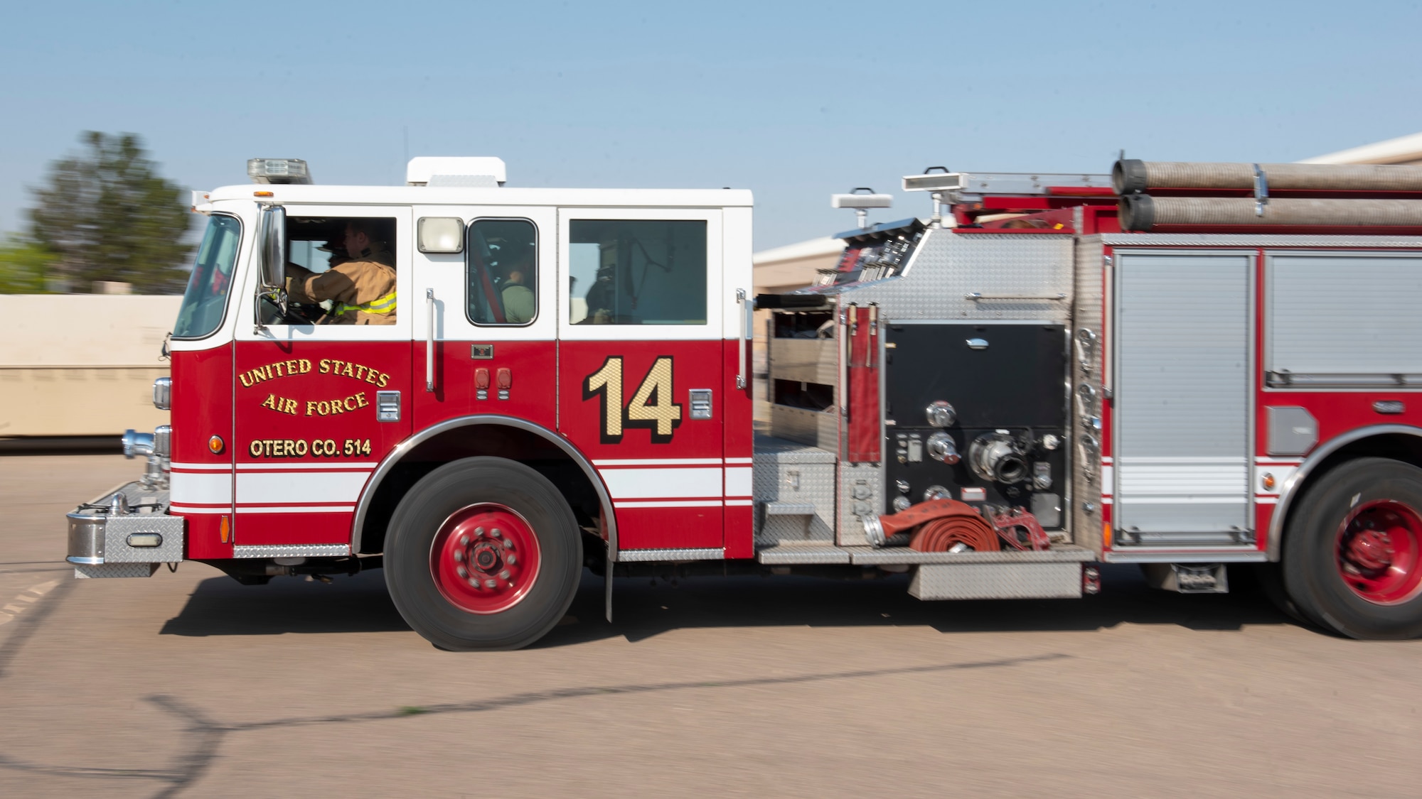 Airmen from the 49th Civil Engineer Squadron drive a fire truck to position it closer to a fire hydrant during an emergency response training exercise, May 19, 2022, on Holloman Air Force Base, New Mexico.