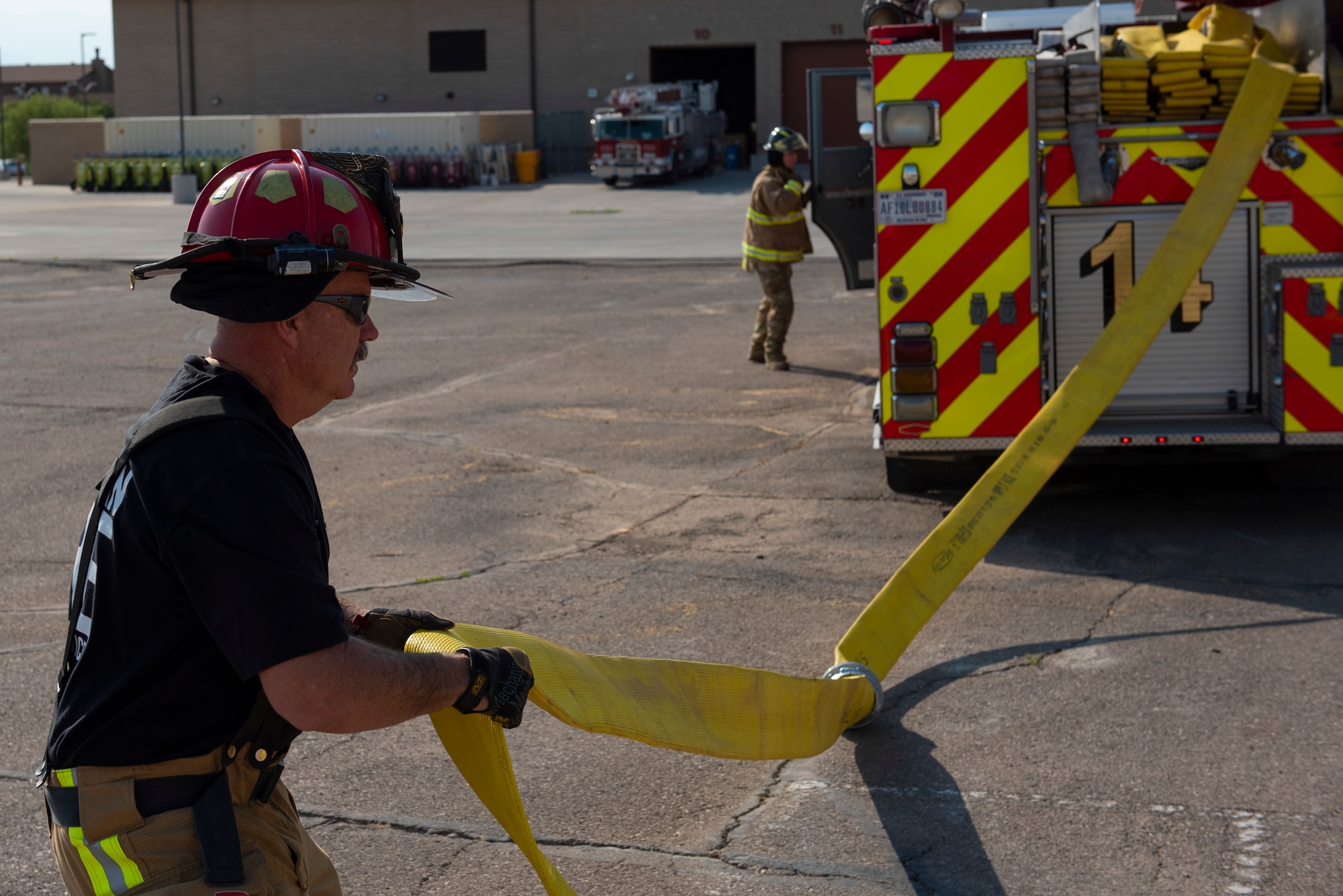 Norman Bloom, 49th Civil Engineer Squadron company officer, prepares to secure a fire hose during an emergency response training exercise, May 19, 2022, on Holloman Air Force Base, New Mexico.