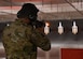 An Airman from the 1st Helicopter Squadron fires his weapon during a shooting competition at the Combat Arms Training and Maintenance Facility on Joint Base Andrews, Md., May 17, 2022. The event honored National Police Week, and competitors who placed in the top 10% were awarded an Excellence in Competition badge. (U.S. Air Force photo by Airman 1st Class Isabelle Churchill)