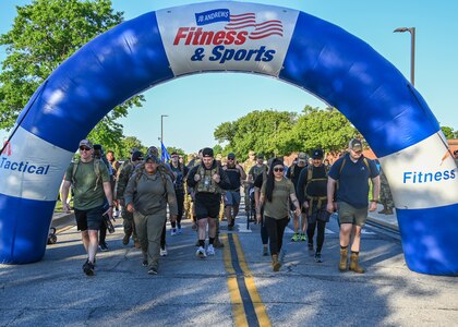 Participants in the National Police Week 5K Memorial Ruck begin their walk at Joint Base Andrews, Md., May 17, 2022. In 1962, President John F. Kennedy designated May 15th as Peace Officers Memorial Day and the week in which that date falls as National Police Week. (U.S. Air Force photo by Airman 1st Class Isabelle Churchill)