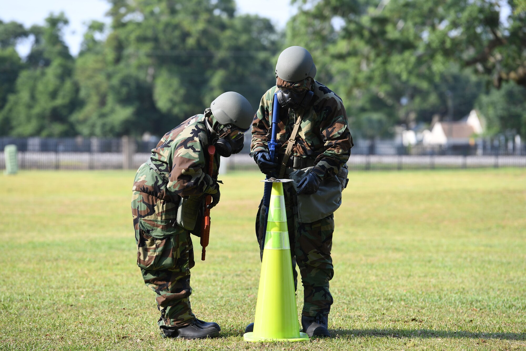 U.S. Air Force Tech. Sgt. Wendi Norton, Second Air Force technical training analyst, and Airman 1st Class Palmer Braga, 81st Logistics Readiness Squadron grounds transportation operator, work to identify a chemical agent during a small scale readiness assessment at Keesler Air Force Base, Mississippi, May 18, 2022. The assessment allowed Keesler personnel to be evaluated on their basic life saving skills in preparation of real-world events. (U.S. Air Force photo by Kemberly Groue)