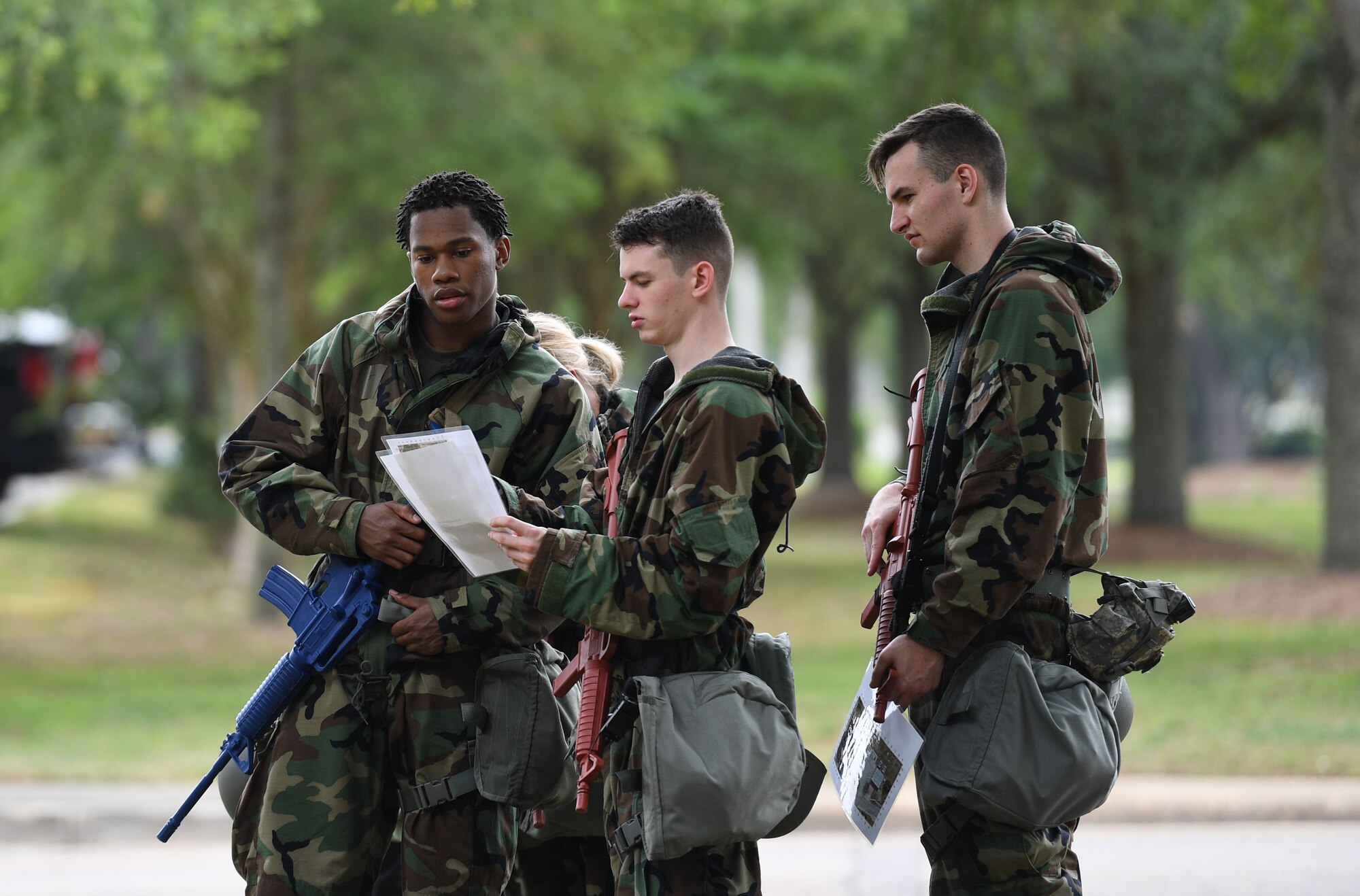 U.S. Air Force 2nd Lt. Phil Mott, 81st Contracting Squadron contract specialist, Senior Airmen Jacob Eason and Logan Kaplan, 81st Logistics Readiness Squadron mechanics, work toU.S. Air Force 2nd Lt. Phil Mott, 81st Co locate and identify unexploded ordinances during a small scale readiness assessment at Keesler Air Force Base, Mississippi, May 18, 2022. The assessment allowed Keesler personnel to be evaluated on their basic life saving skills in preparation of real-world events. (U.S. Air Force photo by Kemberly Groue)