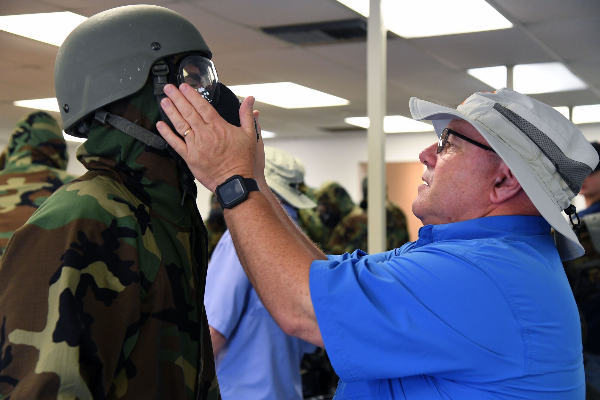 Rich Williams, 81st Force Support Squadron manpower chief, inspects the mask airway of U.S. Air Force Airman 1st Class Andrew Evitts, 81st Contracting Squadron contract specialist, during a small scale readiness assessment at Keesler Air Force Base, Mississippi, May 18, 2022. The assessment allowed Keesler personnel to be evaluated on their basic life saving skills in preparation of real-world events. (U.S. Air Force photo by Kemberly Groue)