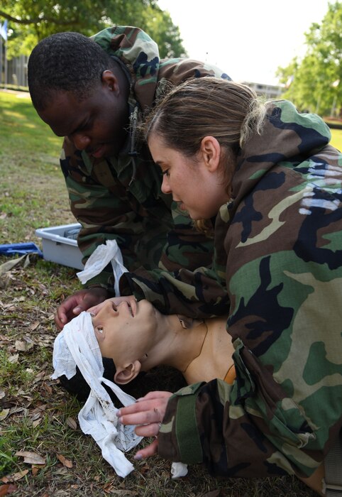 U.S. Air Force Tech. Sgts. Alvin Tilmon, 81st Security Forces Squadron section chief, and Shelymar Cintron, 81st Force Support Squadron assignments noncommsisioned officer in charge, participate in self aid and buddy care assessments during a small scale readiness assessment at Keesler Air Force Base, Mississippi, May 18, 2022. The assessment allowed Keesler personnel to be evaluated on their basic life saving skills in preparation of real-world events. (U.S. Air Force photo by Kemberly Groue)