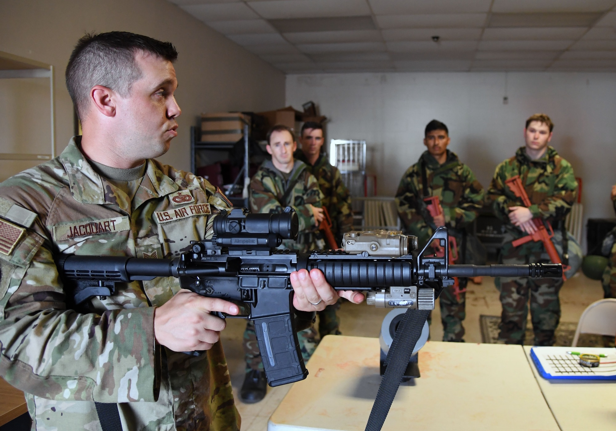 U.S. Air Force Tech. Sgt. Peter Jacquart, 81st Security Forces Squadron standardization and evaluations noncommssioned officer in charge, reviews weapons clearing procedures with Keesler personnel during a small scale readiness assessment at Keesler Air Force Base, Mississippi, May 18, 2022. The assessment allowed Keesler personnel to be evaluated on their basic life saving skills in preparation of real-world events. (U.S. Air Force photo by Kemberly Groue)