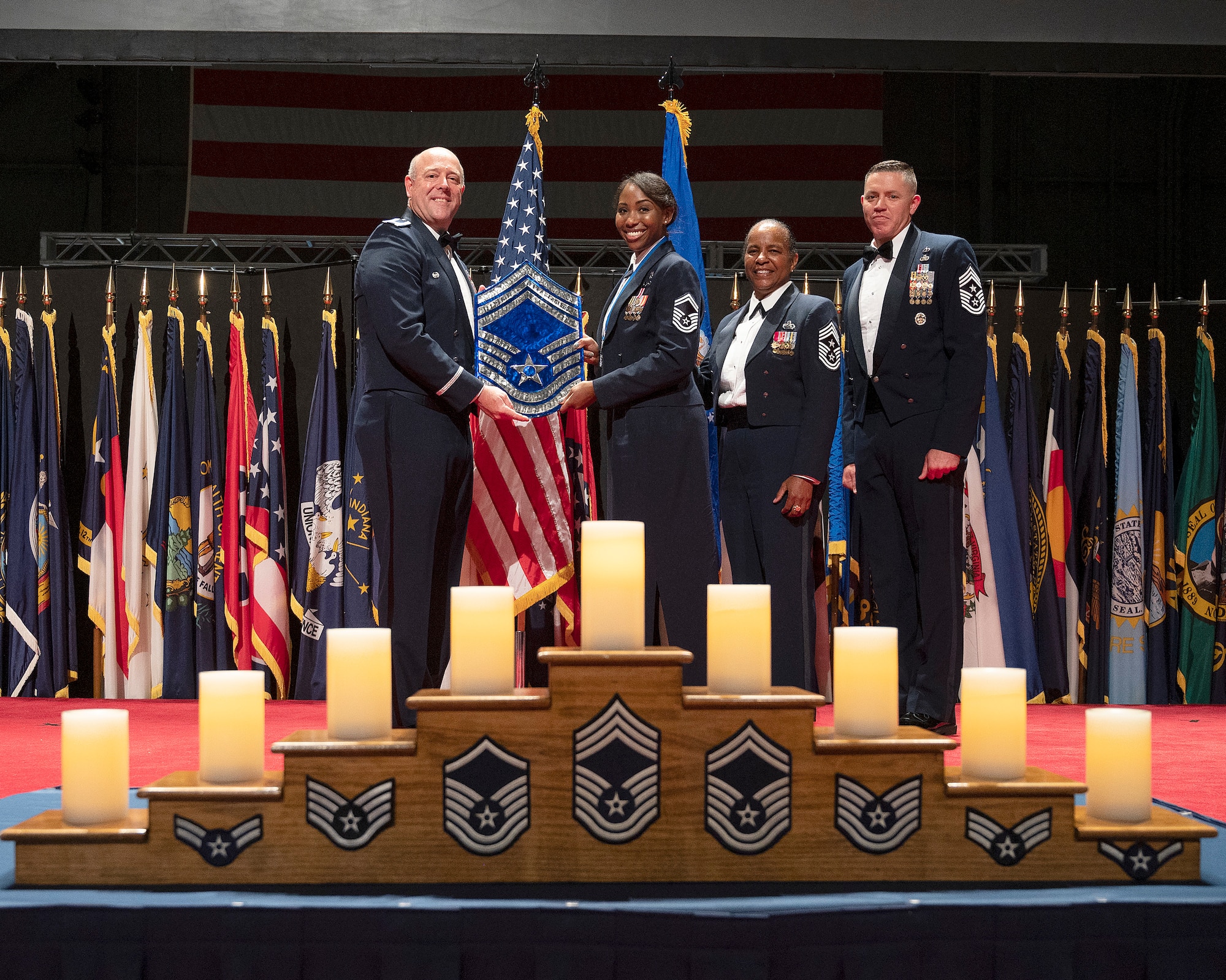 Col. Patrick Miller, 88th Air Base Wing and installation commander, presents a plaque to Chief Master Sgt. Starr Williams, U.S. Air Force School of Aerospace Medicine, during the Wright-Patterson Chief Master Sergeant Recognition Ceremony on May 14, 2022, at the National Museum of the U.S. Air Force. The event honored the Wright-Patt Airmen recently selected for promotion to the Air Force’s highest enlisted rank. (U.S. Air Force photo by R.J. Oriez)