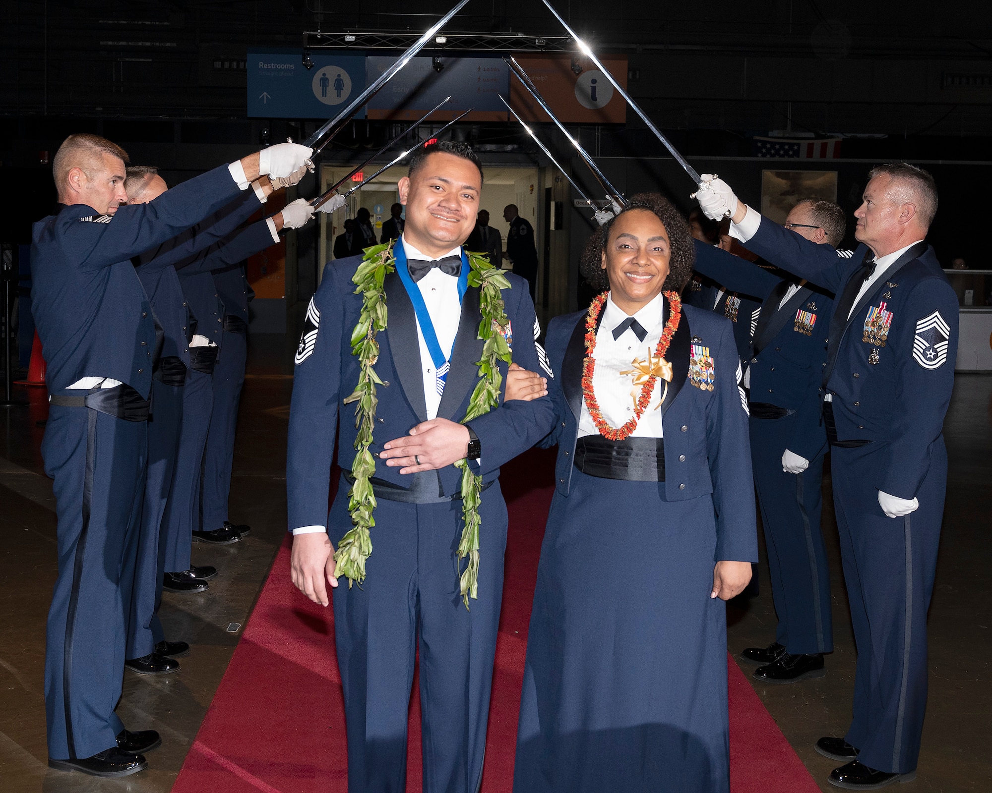 Chief Master Sgt. Derek Maiava and his wife, Chief Master Sgt. Selena Maiava, pause after passing the saber cordon May 14, 2022, as they enter the Wright-Patterson Chief Master Sergeant Recognition Ceremony at the National Museum of the U.S. Air Force. Derek Maiava was honored as one of the Wright-Patterson Airmen recently selected for promotion to the Air Force’s highest enlisted rank. (U.S. Air Force photo by R.J. Oriez)