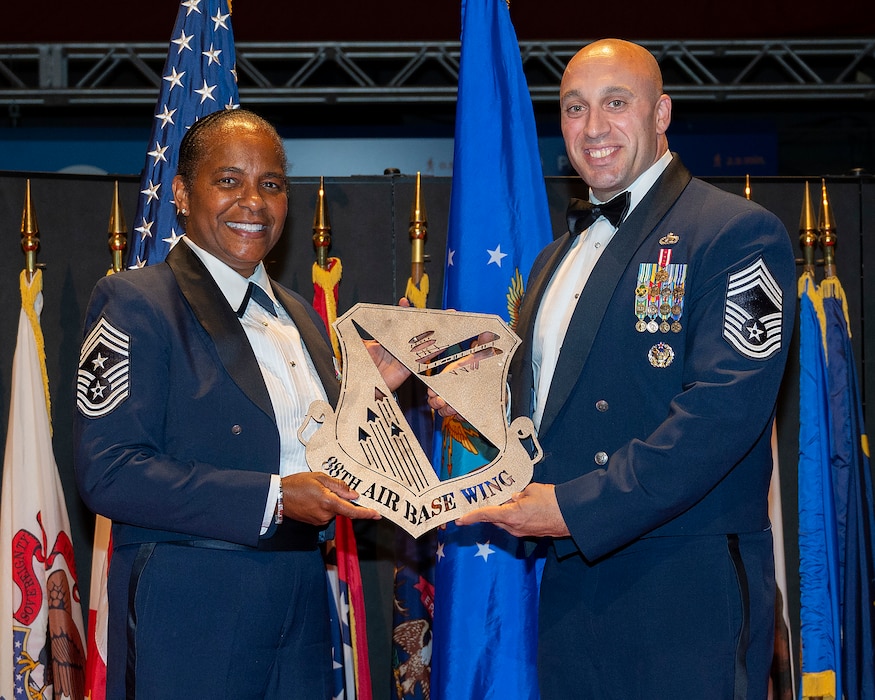 Chief Master Sgt. Joshua Malyemezian presents retired Chief Master Sgt. Shelina Frey with a plaque thanking her for being the guest speaker at the Wright-Patterson Chief Master Sergeant Recognition Ceremony on May 14, 2022, in the National Museum of the U.S. Air Force. Frey is a former command chief for both the 88th Air Base Wing at Wright-Patterson Air Force Base and Air Mobility Command. (U.S. Air Force photo by R.J. Oriez)