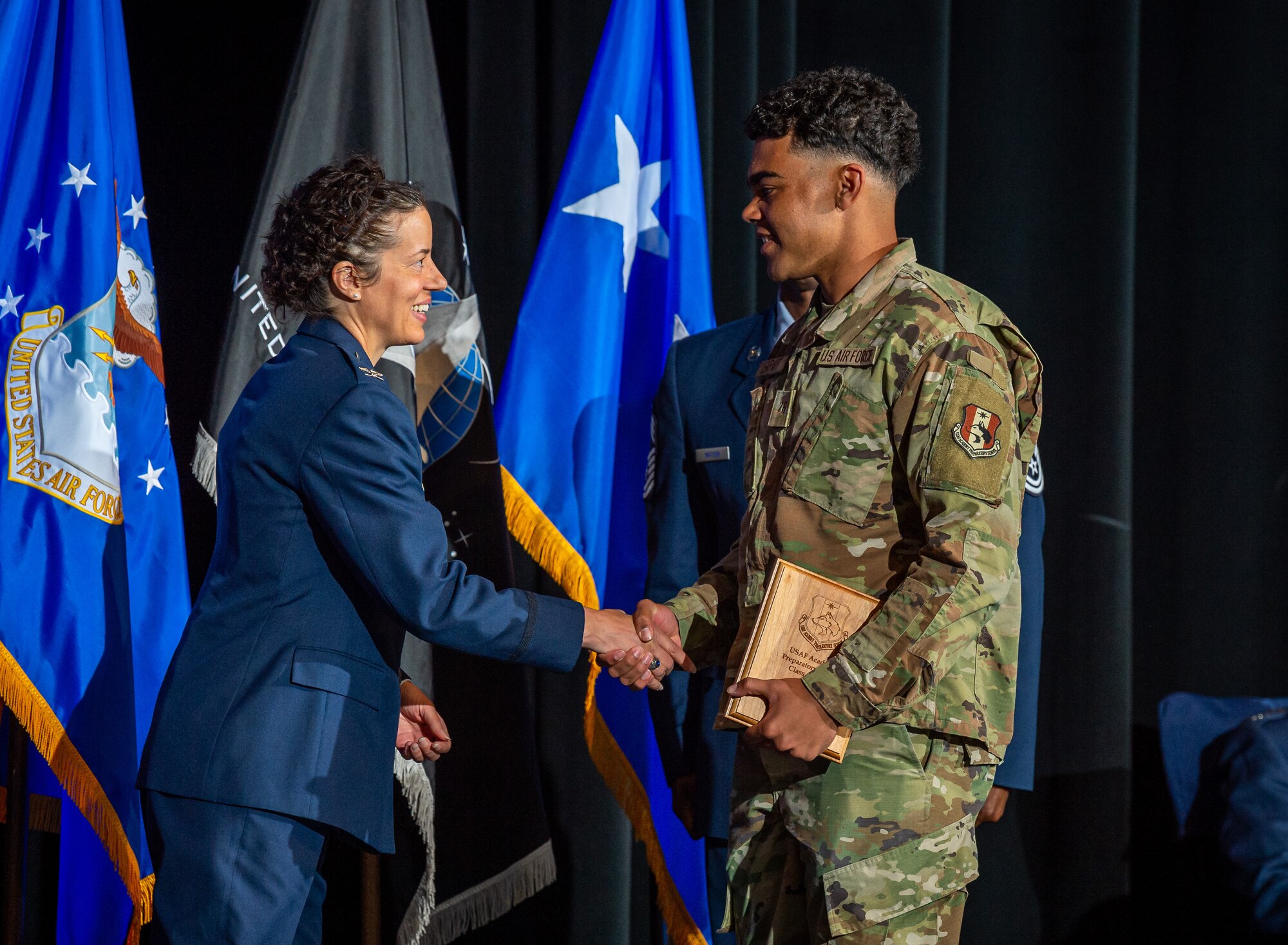 Colonel Melissa Youderian, U.S. Air Force Academy Preparatory School commander, shake the hand of Cadet-Candidate Bryce Matthew Leapart during the prep school's graduation ceremony, May 16.