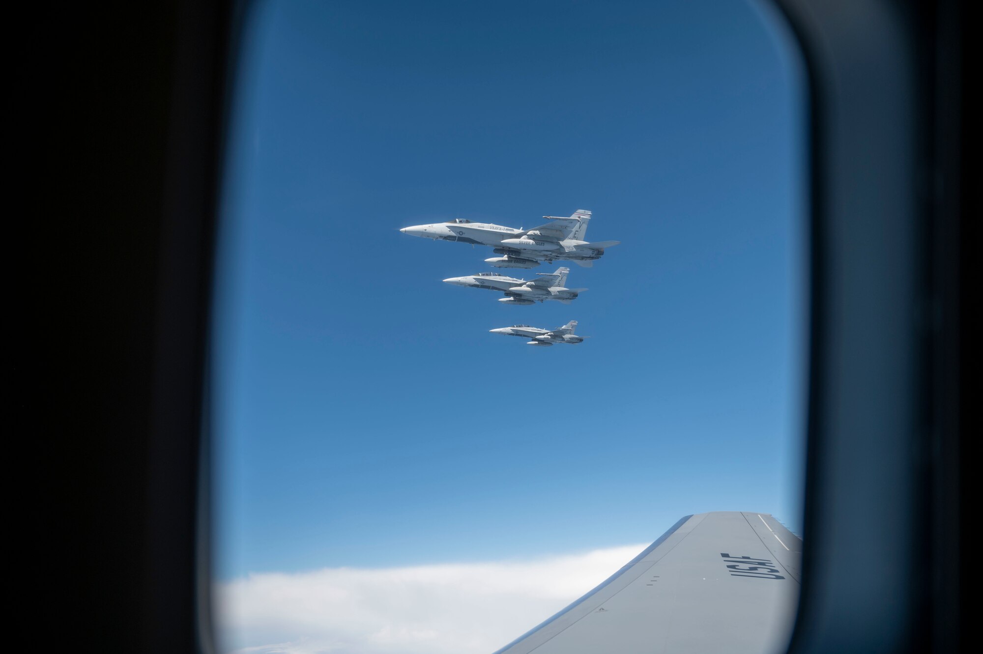 F/A-18s assigned to Marine Fighter Attack Squadron 115 “Silver Eagles” from Marine Corps Air Station Beaufort, South Carolina, fly in formation alongside a KC-46A Pegasus assigned to the 916th Air Refueling Wing from Seymour Johnson Air Force Base, North Carolina, during an aerial refueling operation off the coast of North Carolina following Exercise Razor Talon May 19, 2022. The Silver Eagles were activated on July 1, 1943, and have conducted combat operations during World War II, the Korean War, the Vietnam War and the Global War on Terrorism. (U.S. Air Force photo by Senior Airman Kevin Holloway)
