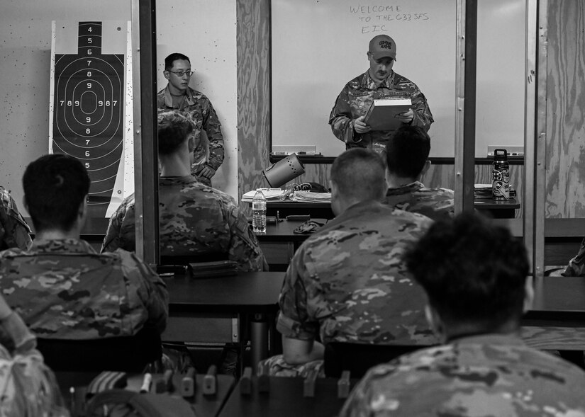 Airmen from across Joint Base Langley-Eustis receive a briefing before participating in a pistol competition at JBLE, Virginia, May 19, 2022.