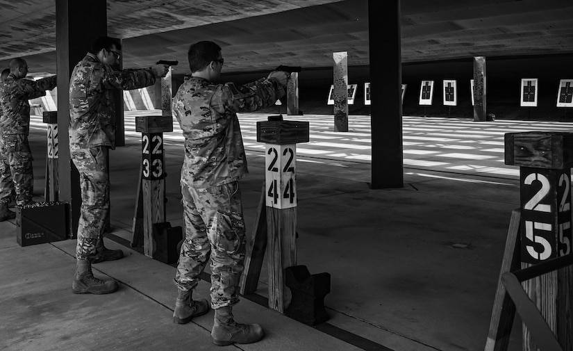 Participants of the 633d Security Forces Squadron Excellence in Competition tournament fire the Beretta M9 pistol at Joint Base Langley-Eustis, Virginia, May 19, 2022.
