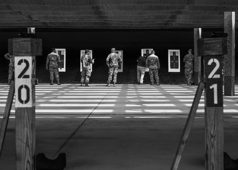 Participants, along with the judges of the 633d Security Forces Squadron Excellence in Competition tournament, evaluate their targets at Joint Base Langley-Eustis, Virginia, May 19, 2022.