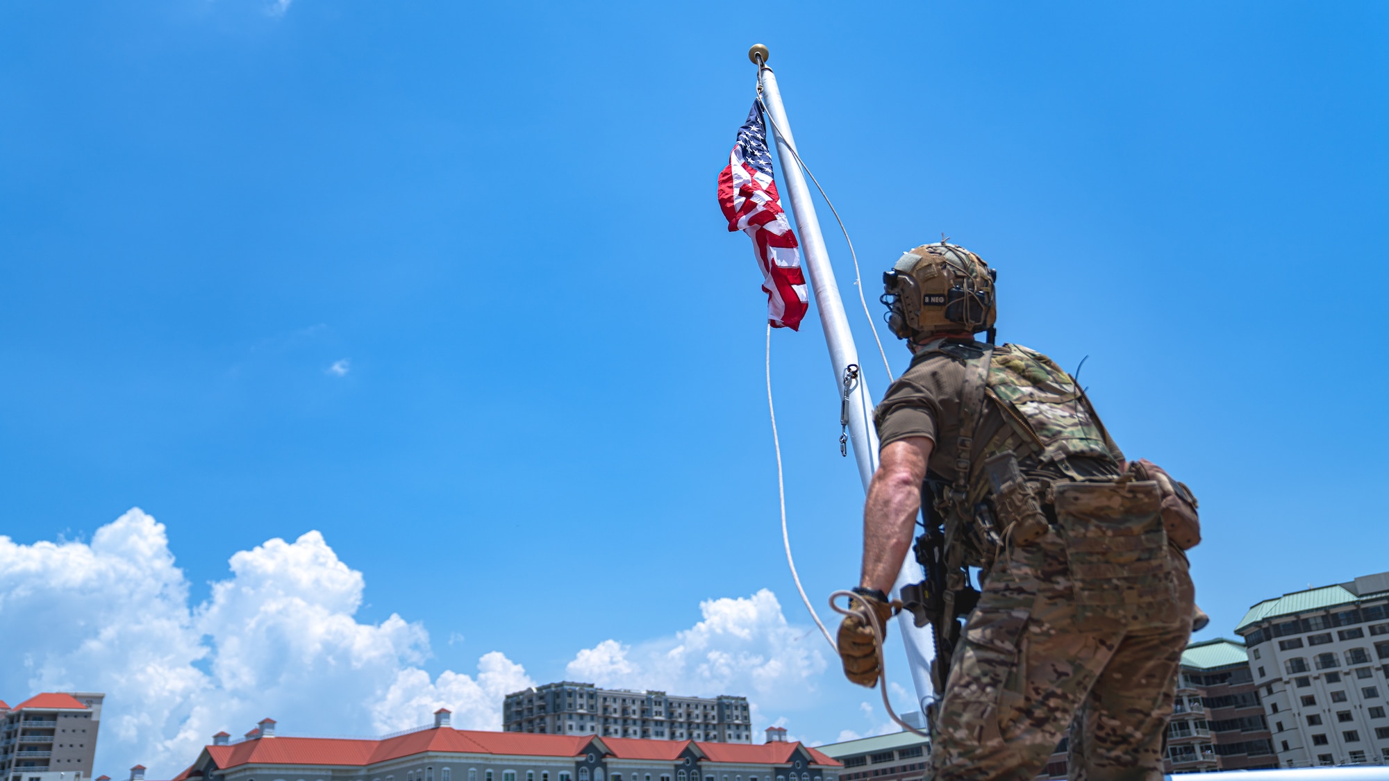 A member assigned to U.S. Special Operations Command hoists an American flag on a boat during a Special Operations Forces (SOF) demonstration in Downtown Tampa, Florida, May 18, 2022.