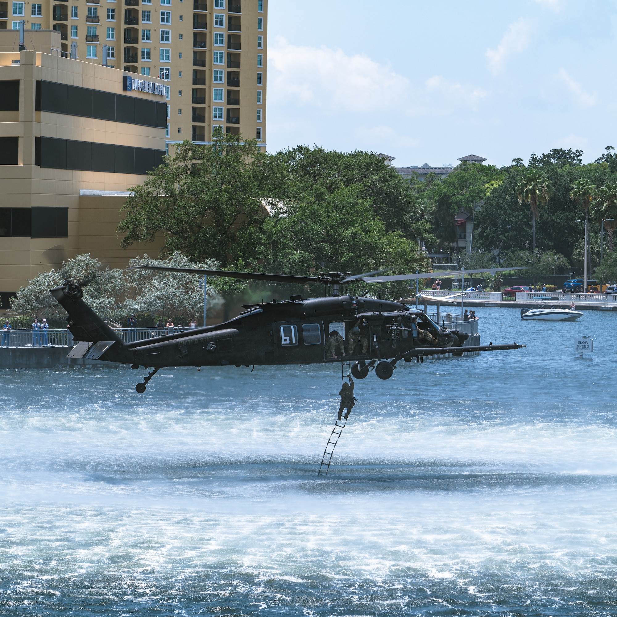 Members assigned to U.S. Special Operations Command execute a simulated rescue mission during a Special Operations Forces (SOF) demonstration in Downtown Tampa, Florida, May 18, 2022.
