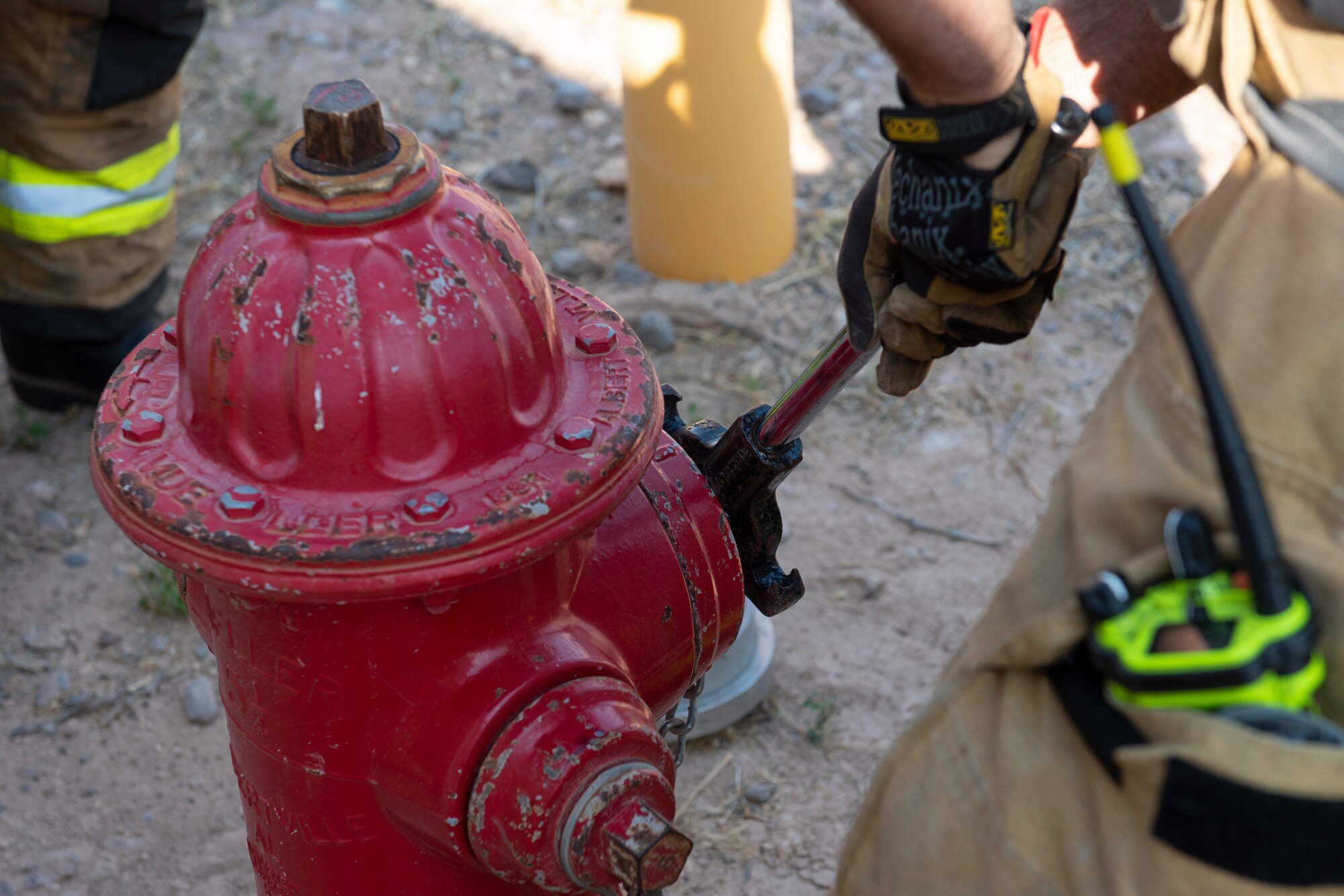 An Airman from the 49th Civil Engineer Squadron secures a fire hydrant during an emergency response training exercise, May 19, 2022, on Holloman Air Force Base, New Mexico.
