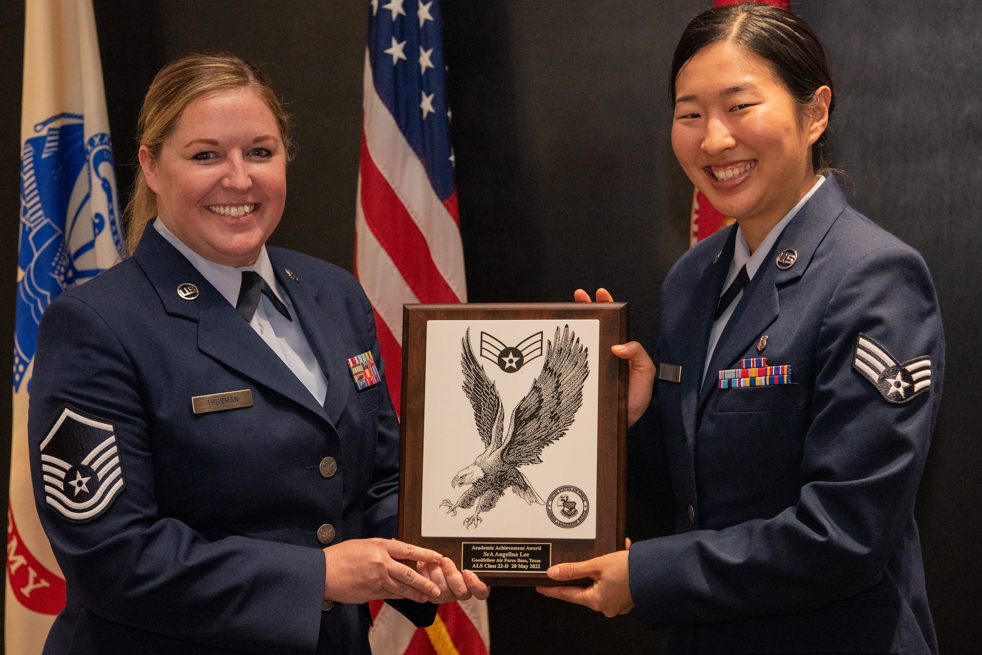 U.S. Air Force Senior Airman Angelina Lee, 17th Healthcare Operations Squadron immunizations technician, receives the academic excellence award during the Airman Leadership School graduation of class 22-D at the Powell Event Center, Goodfellow Air Force Base, Texas, May 20, 2022. The academic excellence award is given to the graduate with the best performance in performance tasks and the capstone exercise. (U.S. Air Force Photo by Senior Airman Michael Bowman)