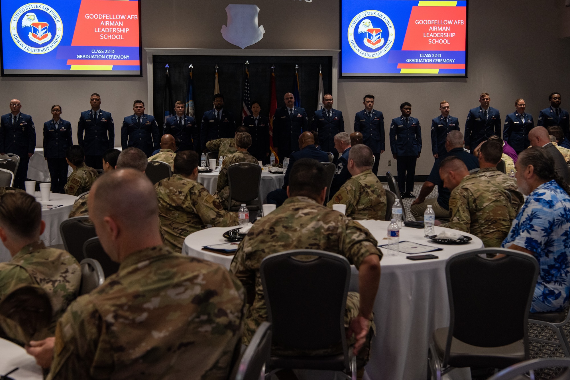 U.S. Air Force graduates of Airman Leadership School class 22-D sing the Air Force song at the end of their graduation ceremony at the Powell Event Center, Goodfellow Air Force Base, Texas, May 20, 2022. ALS is designed to prepare Airmen to take on larger responsibilities as they become supervisors. (U.S. Air Force Photo by Senior Airman Michael Bowman)