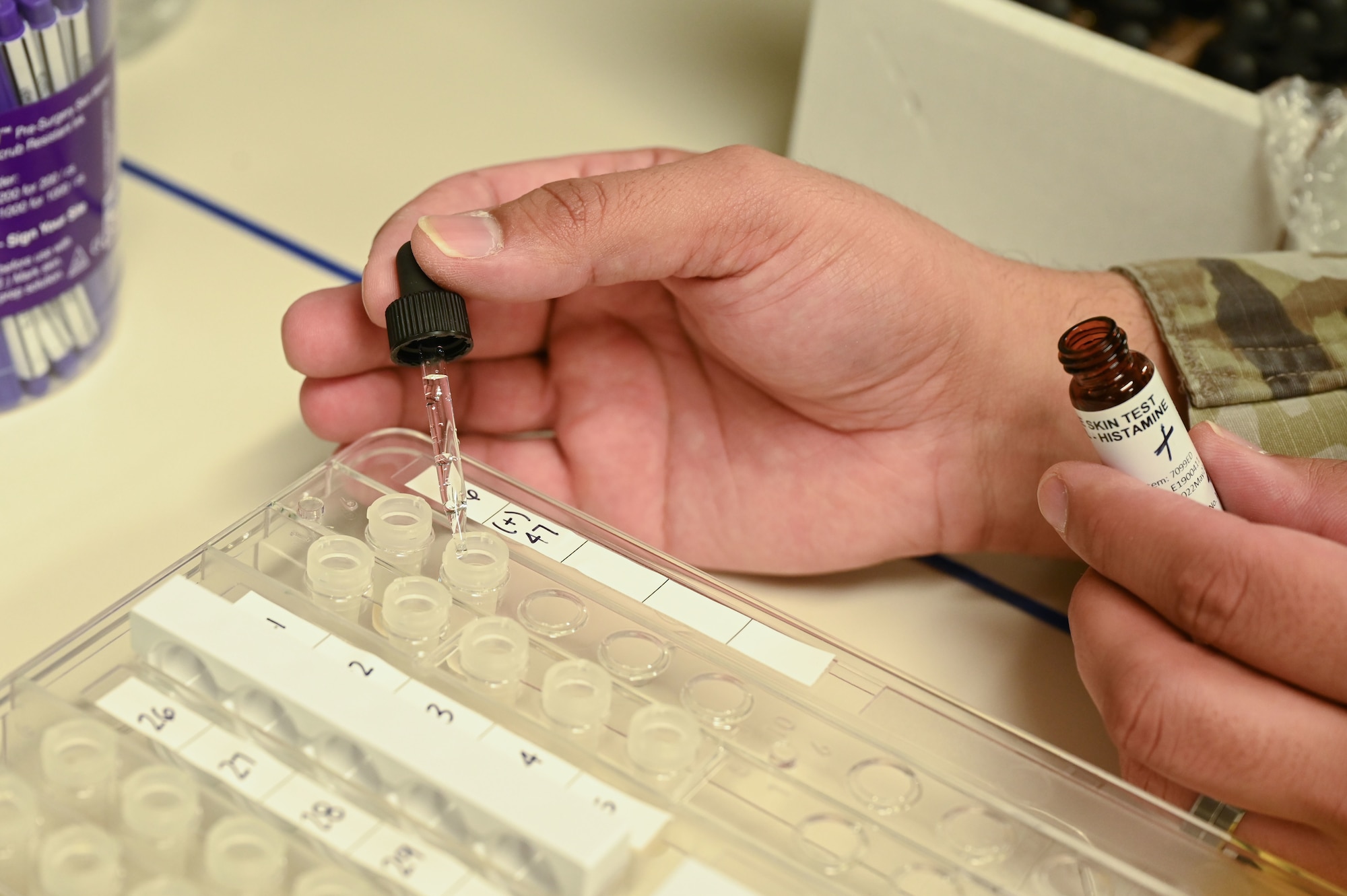 A dropper drops fluid into a panel.