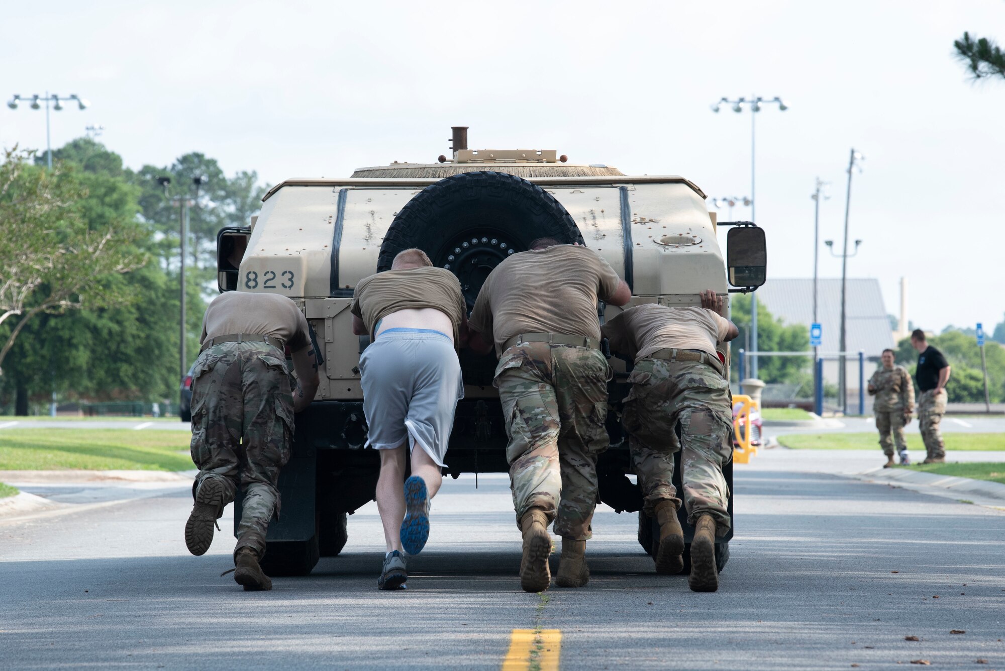 U.S. Air Force Airmen assigned to the 23rd Security Forces Squadron push a humvee during a fireteam gauntlet for National Police Week at Moody Air Force Base, Georgia, May 20, 2022. The fireteam gauntlet tested various teams’ skills in strenuous athletic and mental challenges. (U.S. Air Force photo by Staff Sgt. Thomas Johns)
