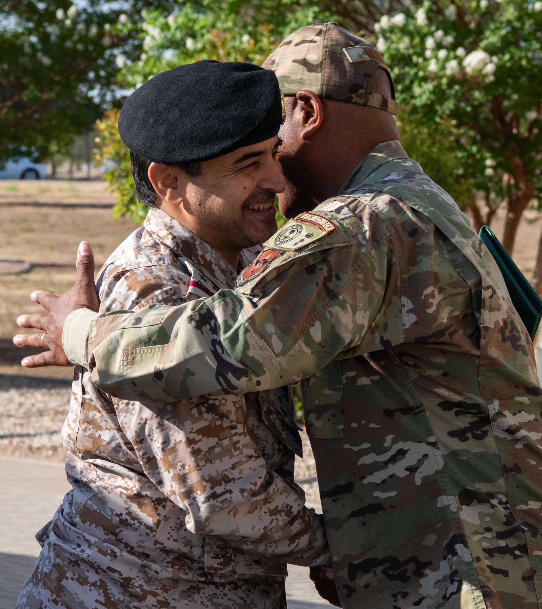 Royal Saudi Air Forces Commodore Al Mutairi Sattam Thaib, Armed Forces Intel and Security Institute commander, embraces U.S. Air Force Col. Euguene Moore III, 17th Mission Support Group commander, Goodfellow Air Force Base, May 18, 2022. Members of the RSAF visited Goodfellow AFB to learn about the joint and coalition forces intelligence, surveillance, and reconnaissance training provided by the 17th Training Wing. (U.S. Air Force Photo by Senior Airman Michael Bowman)