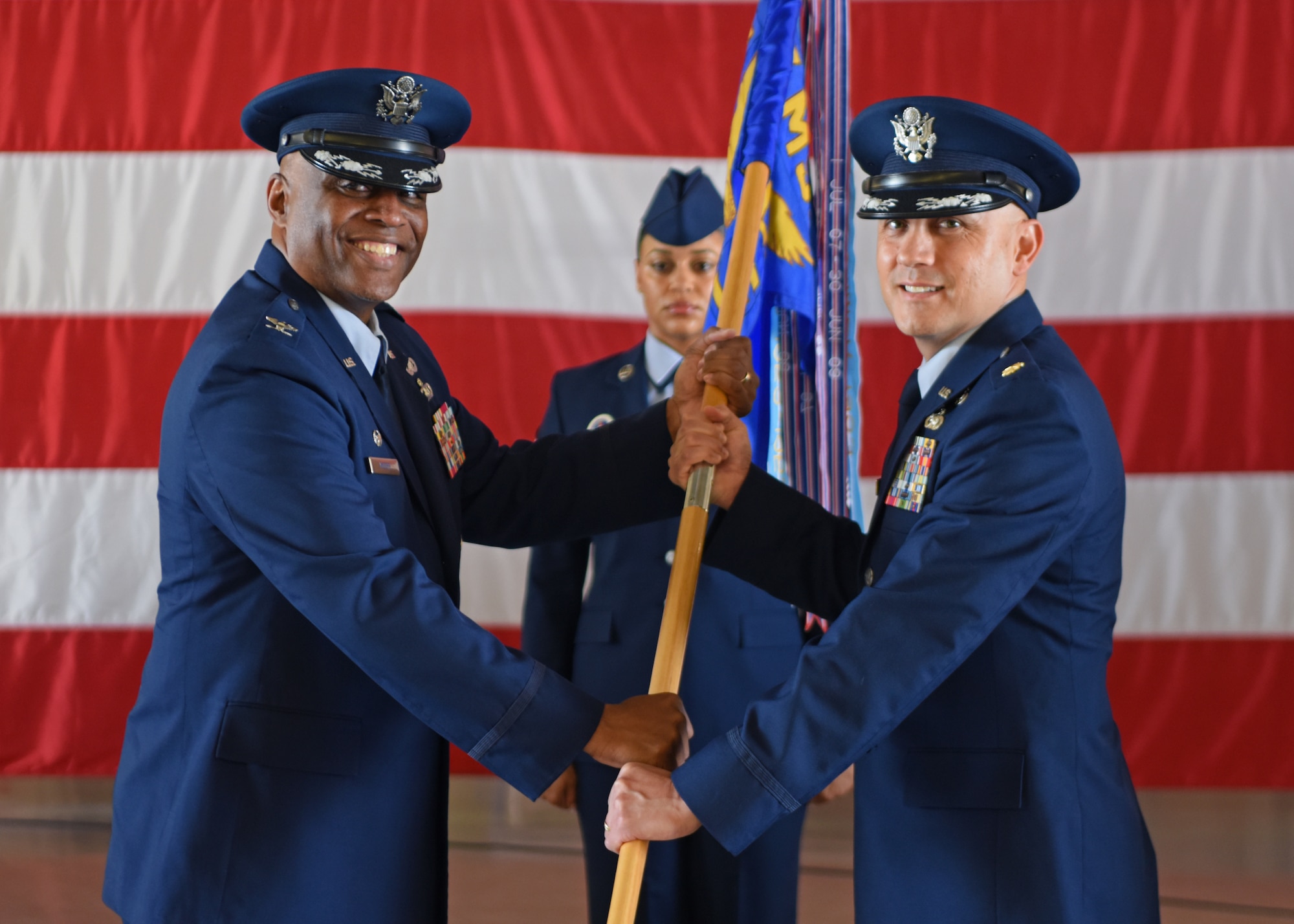U.S. Air Force Maj. Jose Quintanilla, 17th Logistics Readiness Squadron incoming commander, (right) assumes command from Col. Eugene Moore III, 17th Mission Support Group commander, during the 17th LRS change of command ceremony at Goodfellow Air Force Base, Texas, May 20, 2022. Changes of command are a military tradition representing the transfer of responsibilities from the presiding official to the upcoming official. (U.S. Air Force photo by Senior Airman Ethan Sherwood)