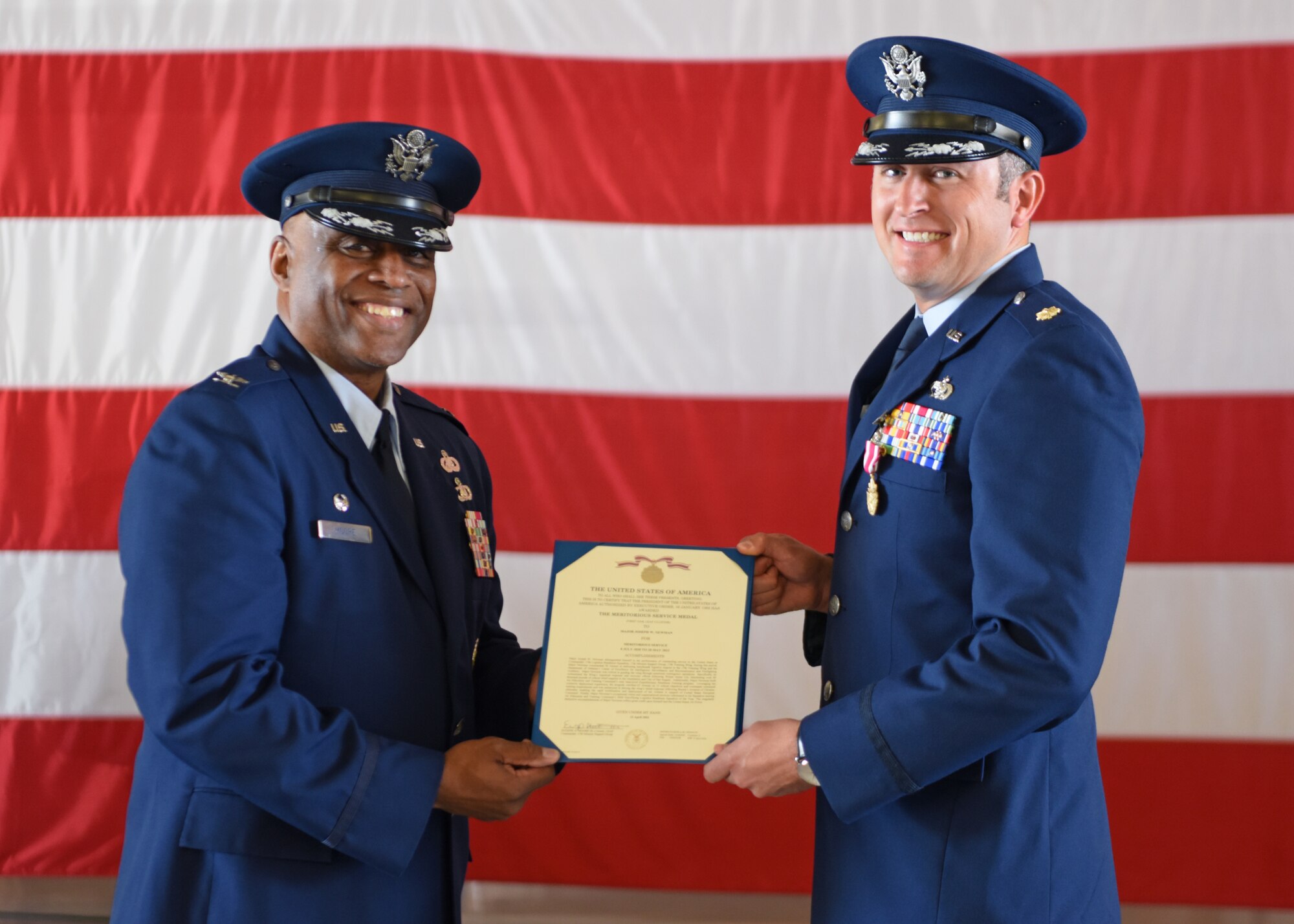 U.S. Air Force Col. Eugene Moore III, 17th Mission Support Group commander, (left) presents a Meritorious Service Medal to Maj. Joseph Freeman, 17th Logistics Readiness Squadron outgoing commander, at the 17th LRS change of command ceremony at Goodfellow Air Force Base, Texas, May 20, 2022. Freeman served through both a pandemic and Winter Storm Uri and led the 17th LRS with excellence. (U.S. Air Force photo by Senior Airman Ethan Sherwood)