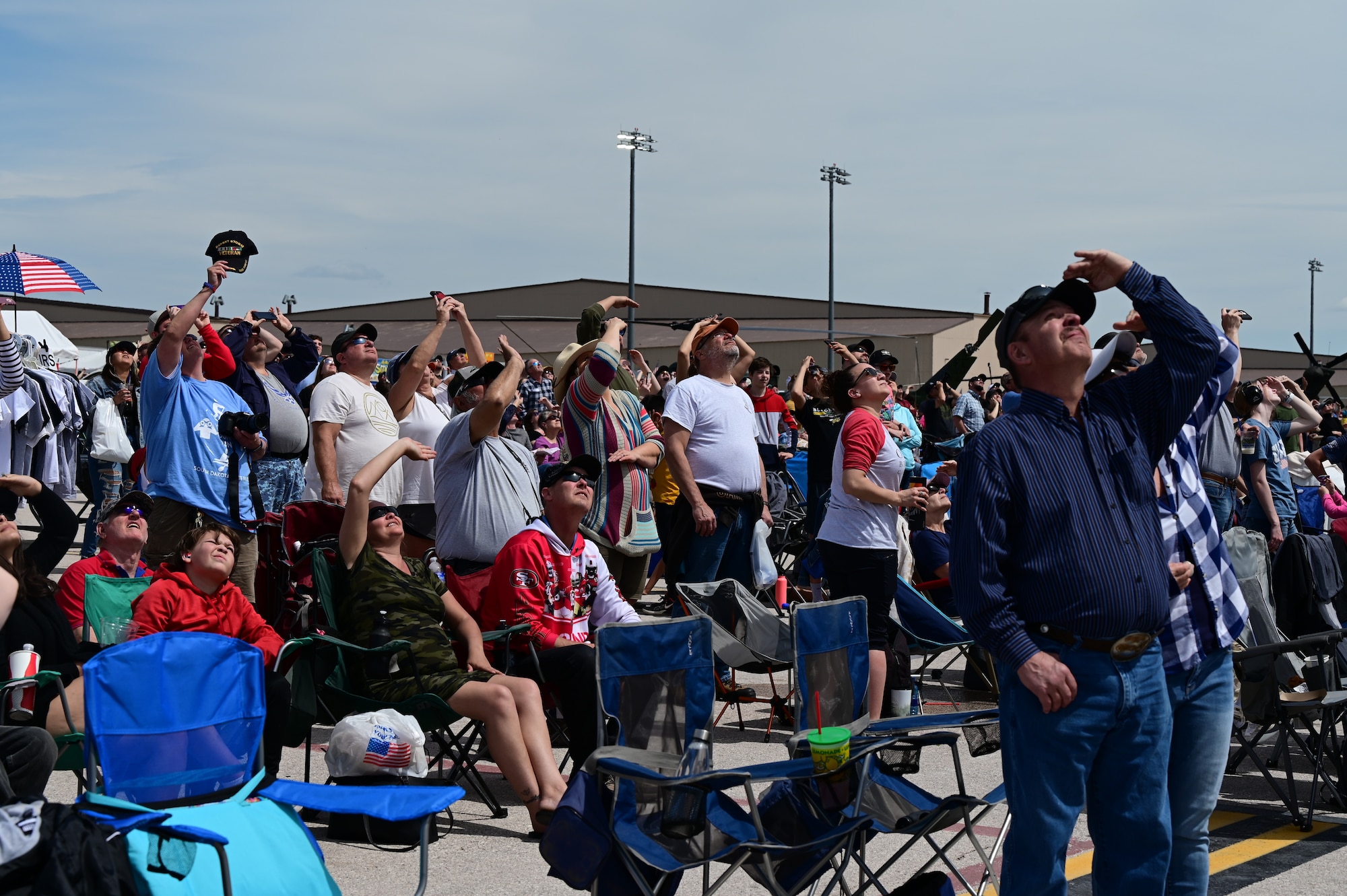 Attendees at the 2022 Ellsworth Air and Space Show watch as an F-22 Raptor soars above    Ellsworth Air Force Base, S.D., May 15, 2022. This was Ellsworth’s first airshow since 2015 and hosted over 60,000 guests. (U.S. Air Force photo by Staff Sgt. Hannah Malone)