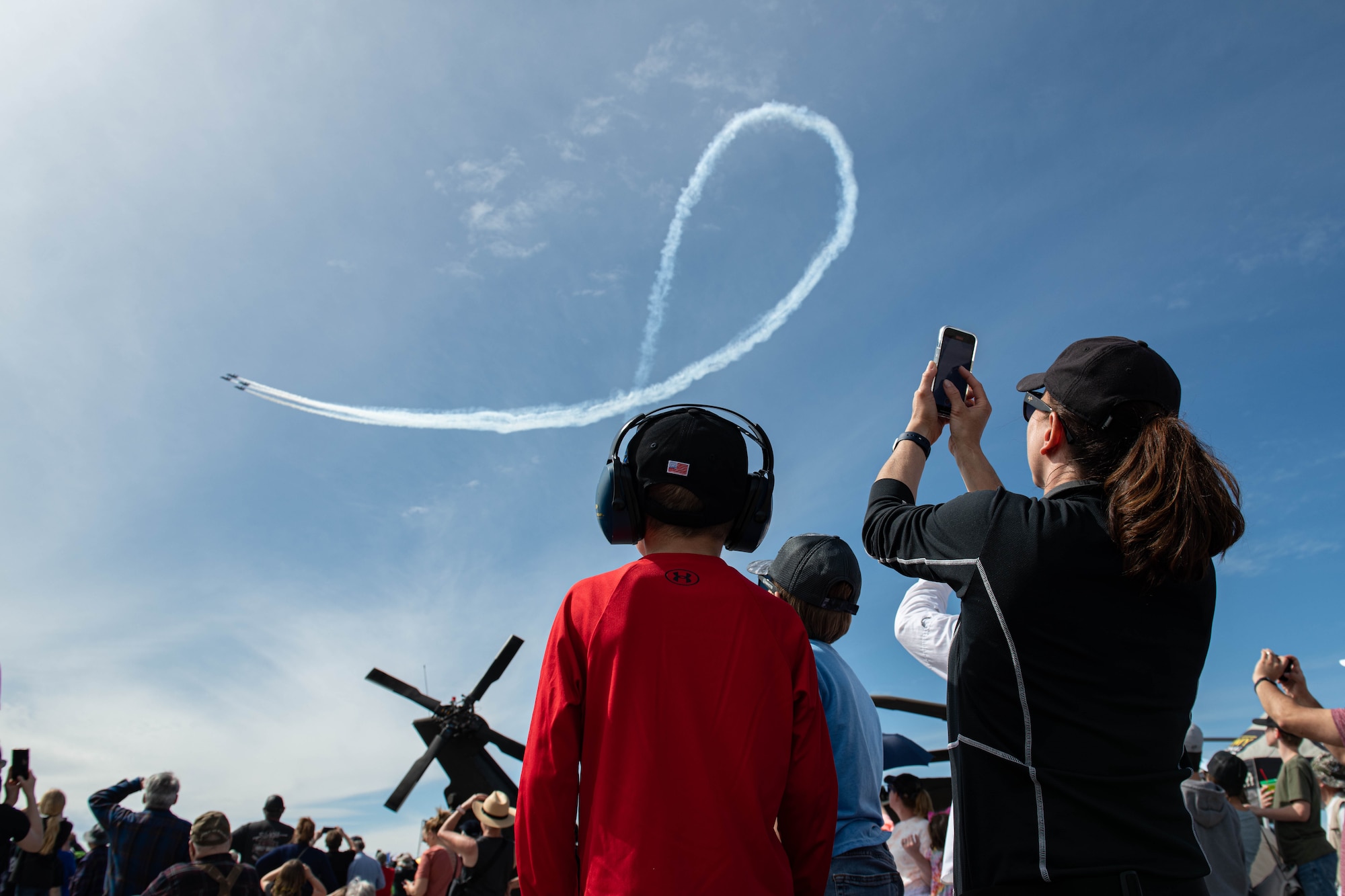 Audience members observe the U.S. Navy Flight Demonstration Squadron, the Blue Angels, perform during the 2022 Ellsworth Air and Space Show at Ellsworth Air Force Base, S.D., May 14, 2022. During airshows the Blue Angels often perform a Diamond 360 maneuver, where the jets fly only 18 inches apart. (U.S. Air Force photo by Senior Airman Quentin Marx)
