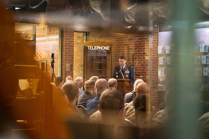 U.S. Air Force Col. James Hewitt, 688th Cyberspace Wing commander, gives a speech at a timeline induction ceremony, at HQ Cyberspace Capabilities Center on Scott Air Force Base, Illinois, May 19, 2022. Hewitt shared his words of appreciation for the hard work and dedication that enabled a cyber-effect to travel from San Antonio, through an aircraft and delivered to a ground target across the globe for the first time in 2015. (U.S. Air Force photo by Airman 1st Class Mark Sulaica)