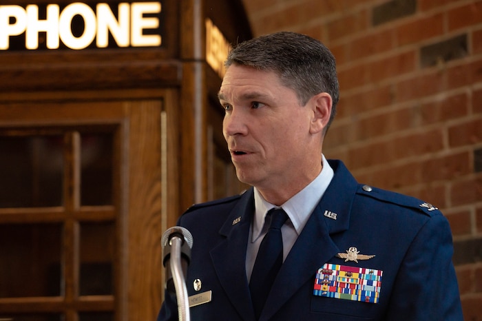 U.S. Air Force Col. James Hewitt, 688th Cyberspace Wing commander, gives a speech at a timeline induction ceremony, at HQ Cyberspace Capabilities Center on Scott Air Force Base, Illinois, May 19, 2022. Hewitt shared his words of appreciation for the hard work and dedication that enabled a cyber-effect to travel from San Antonio, through an aircraft and delivered to a ground target across the globe for the first time in 2015. (U.S. Air Force photo by Airman 1st Class Mark Sulaica)