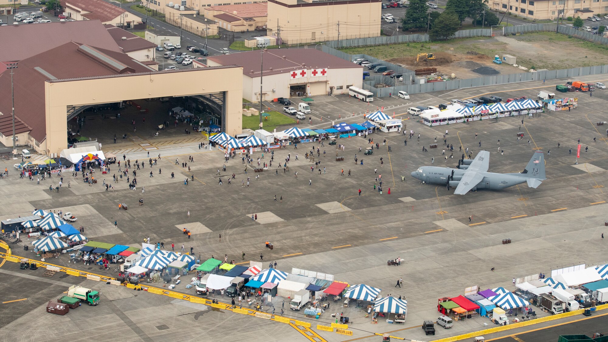Visitors begin to spread out over the festival grounds during the Friendship Festival 2022, at Yokota Air Base, Japan, May 21, 2022. The two-day festival was an opportunity for visitors to learn more about the U.S. and Japan bilateral partnership, while strengthening the bonds between Yokota and the local communities. Yokota was able to host the event with the support of Japanese Self-Defense Force, sister services and the local community. (U.S. Air Force photo by Staff Sgt. Ryan Lackey)