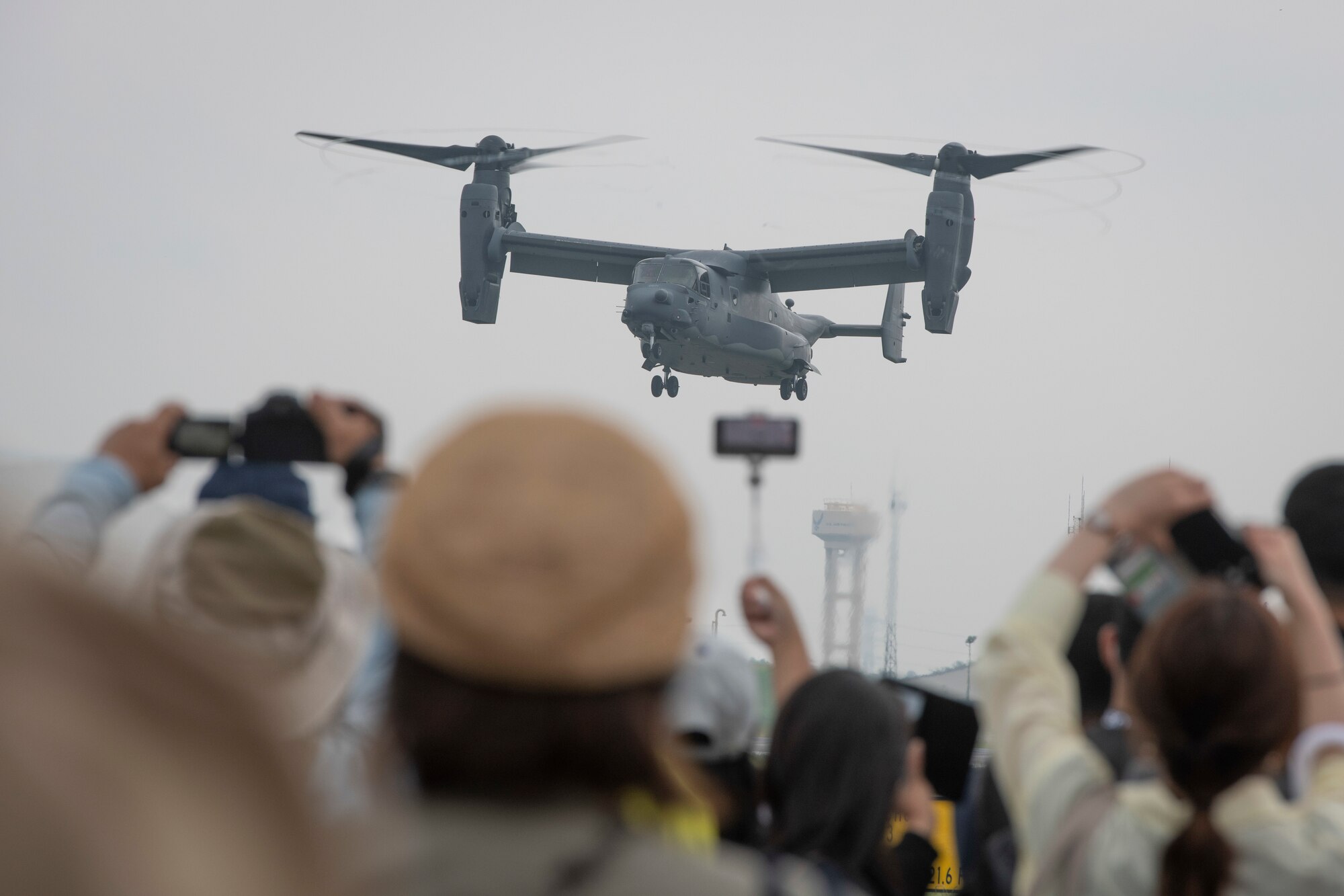Attendees watch the demonstration of CV-22 Osprey capabilities exercise during Friendship Festival 2022, at Yokota Air Base, Japan, May 21. The demonstration was one of many events during the weekend that showcased U.S. military capabilities. (U.S. Air Force photo by Machiko Arita)