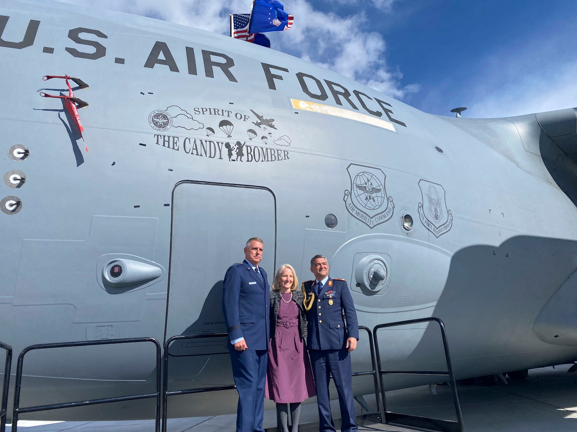 U.S. Air force Gen. Mike Minihan, Air Mobility Command commander, stands with Denise Williams and a German attache in front of a C-17 Globemaster III dedicated the "Spirit of the Candy Bomber" in Provo, Utah, May 20, 2022.