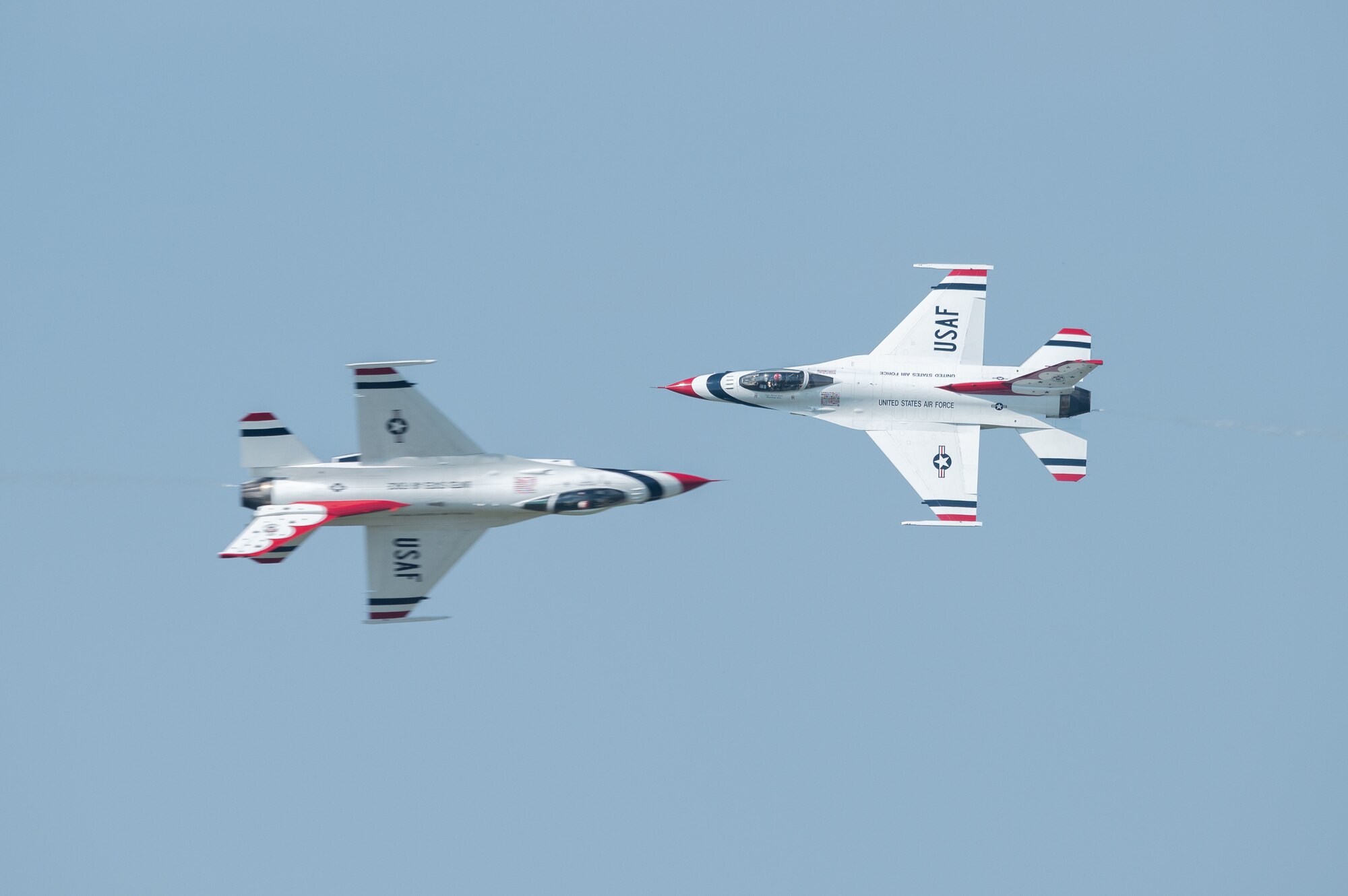 Two members of the U.S. Air Force Thunderbirds perform a high-speed cross over pass during the first day of the 2022 Thunder Over Dover Airshow, May 21, 2022, at Dover Air Force Base, Delaware. The Thunderbirds performed precision flying maneuvers during the 2022 Thunder Over Dover Open House and Airshow May 21-22. (U.S. Air Force photo by Mauricio Campino)