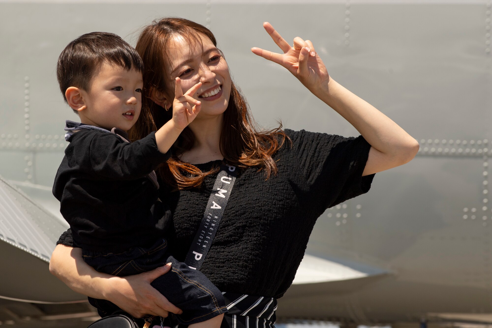 A festival attendee and her son pose for a picture in front of a C-12 Huron belonging to the 459th Airlift Squadron, during the Friendship Festival 2022, at Yokota Air Base, Japan, May 22, 2022. The two-day festival was an opportunity for visitors to learn more about the U.S. and Japan bilateral partnership, while strengthening the bonds between Yokota and the local communities. Yokota was able to host the event with the support of Japanese Self-Defense Force, sister services and the local community. (U.S. Air Force photo by Staff Sgt. Ryan Lackey)