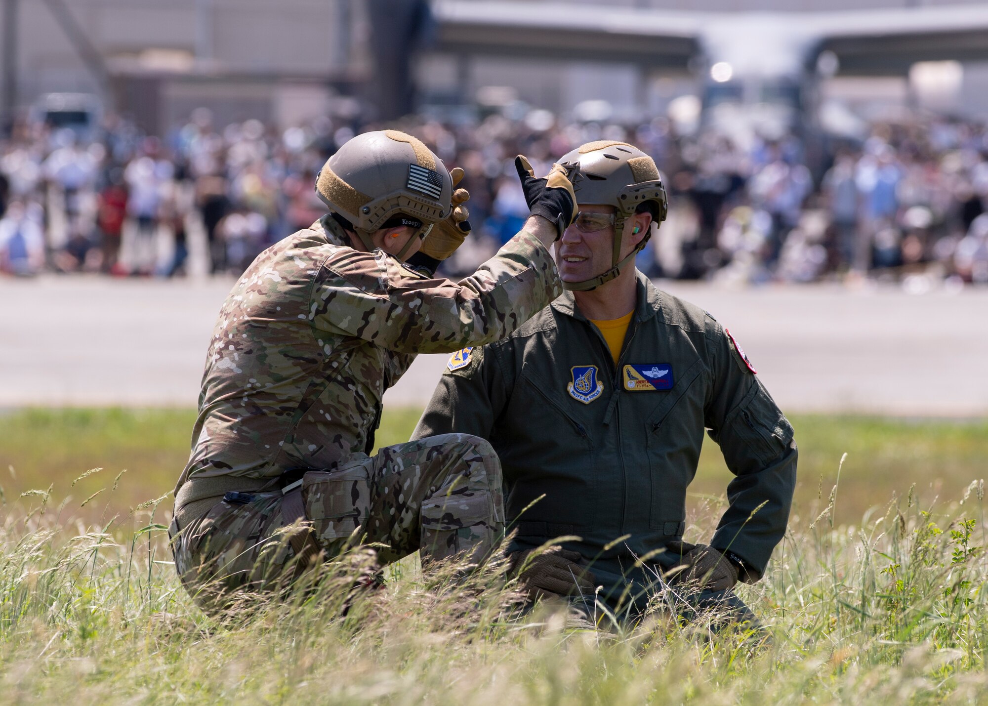 Col. Andrew Campbell, 374th Airlift Wing commander, is briefed on how to don a sling harness by Tech. Sgt. Mark Rosenboom, 374th Operational Support Squadron Survival Evasion Resistance Escape specialist, during a UH-1 rescue demonstration at the Friendship Festival 2022, at Yokota Air Base, Japan, May 22, 2022. The two-day festival was an opportunity for visitors to learn more about the U.S. and Japan bilateral partnership, while strengthening the bonds between Yokota and the local communities. Yokota was able to host the event with the support of Japanese Self-Defense Force, sister services and the local community. (U.S. Air Force photo by Staff Sgt. Ryan Lackey)