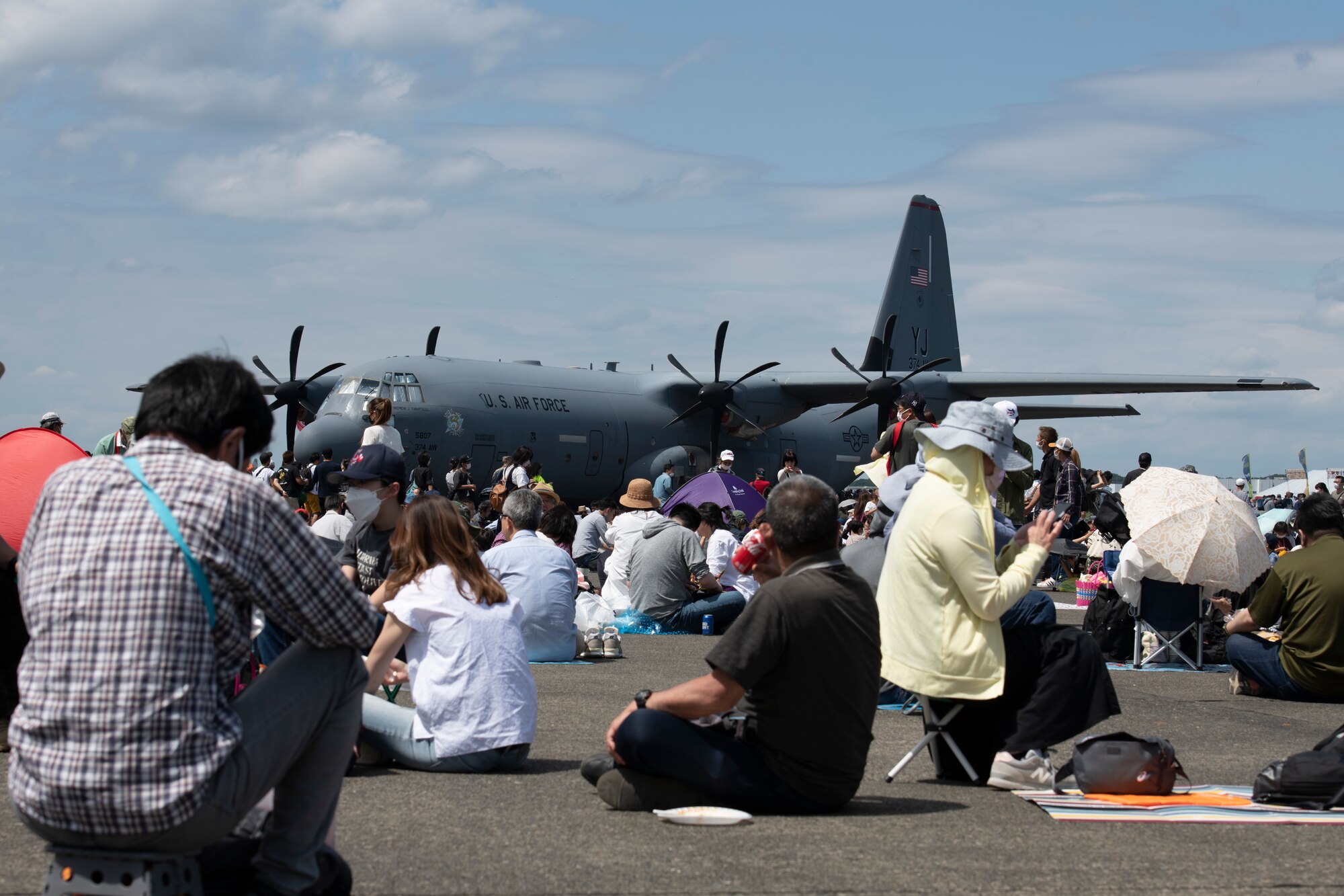 Attendees rest and eat lunch during Friendship Festival 2022, at Yokota Air Base, Japan, May 22. The two-day festival was an opportunity for visitors to learn more about the U.S. and Japan bilateral partnership, while strengthening the bonds between Yokota and the local communities. Yokota was able to host the event with the support of Japanese Self-Defense Force, sister services and the local community. (U.S. Air Force photo by Tech. Sgt. Joshua Edwards)