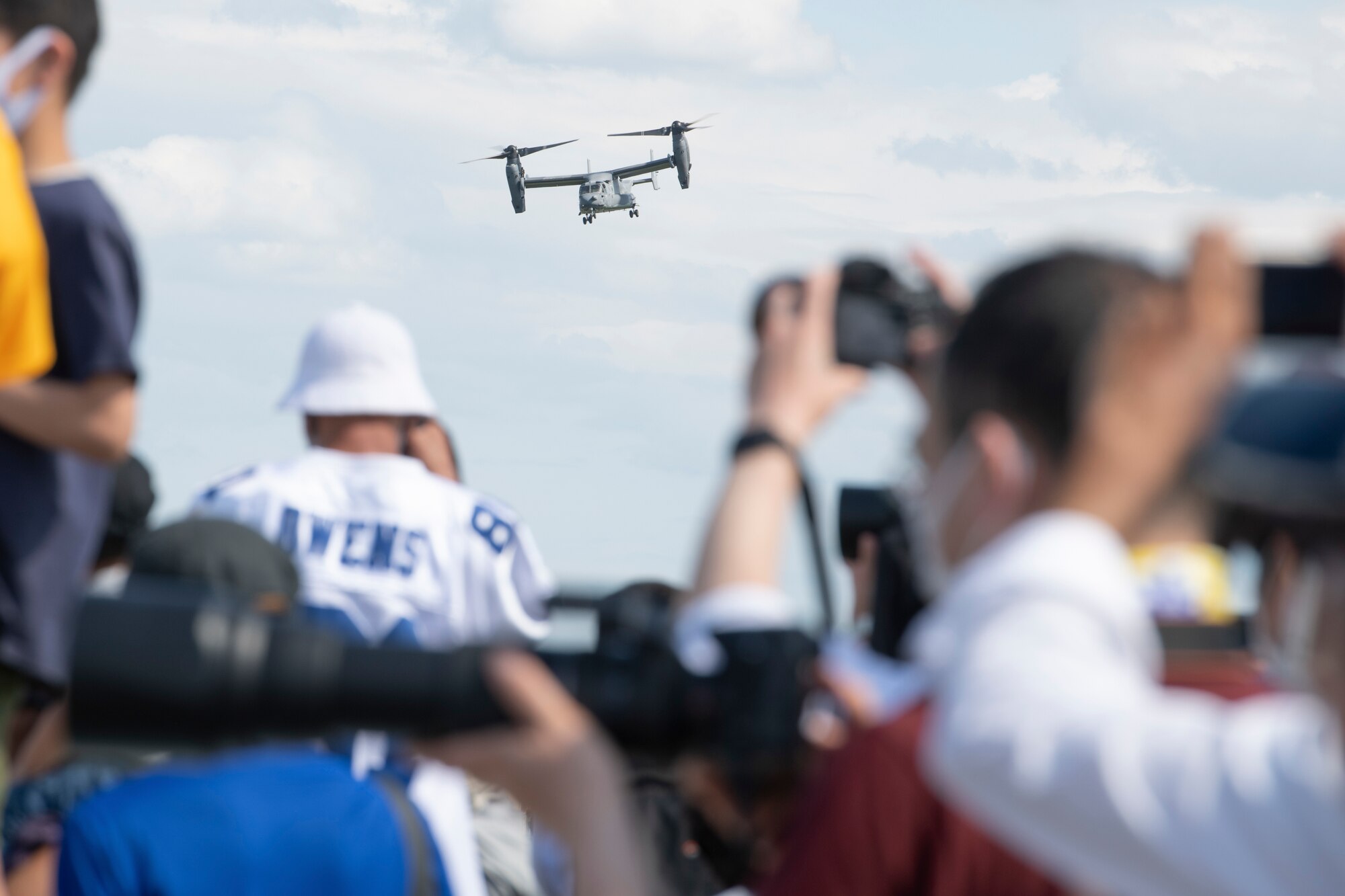 Attendees watch a demonstration of CV-22 Osprey capabilities exercise during Friendship Festival 2022, at Yokota Air Base, Japan, May 22. The demonstration was one of many events during the weekend that showcased U.S. military capabilities. (U.S. Air Force photo by Machiko Arita)