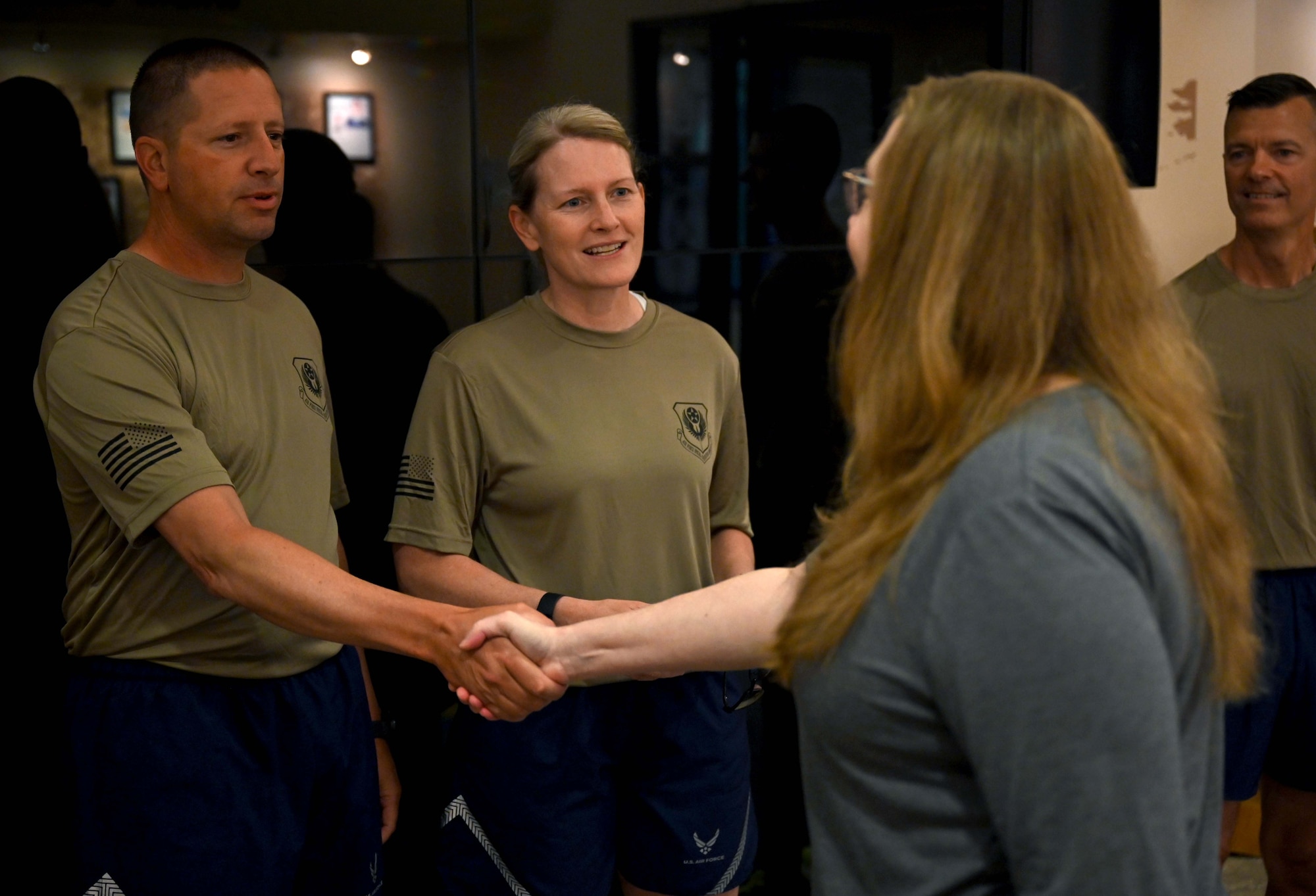 U.S. Air Force Col. Jocelyn Schermerhorn, commander of the 1st Special Operations Wing, and Chief Master Sgt. Courtney Freeman, command chief of the 1st SOW, greet a family member of a fallen Air Force Special Operations Command member during the AFSOC Run to Honor 5k Run/Ruck at Hurlburt Field, Florida May 13, 2022. The command hosts the run/ruck as a tribute to AFSOC Airmen who have made the ultimate sacrifice in service to their country. (U.S. Air Force photo by Staff Sgt. Brandon Esau)