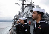 Yeoman 2nd Class Jeremiah Alisea mans the rails aboard the Arleigh Burke-class guided-missile destroyer USS Porter (DDG 78), as the ship prepares to pull into Oslo, Norway, for a scheduled port visit May 22, 2022. Porter is on a scheduled deployment in the U.S. Naval Forces Europe area of operations, employed by U.S. Sixth Fleet to defend U.S., Allied and Partner interests.