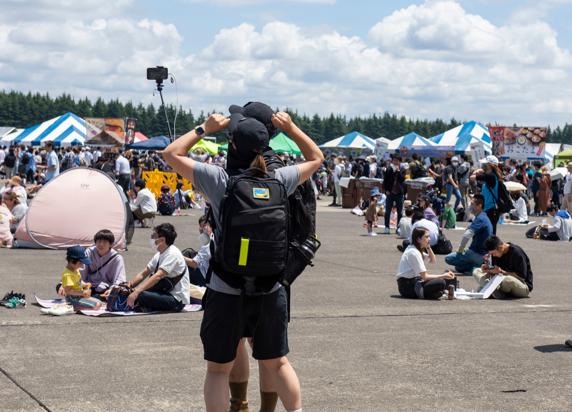 Attendees pose for a selfie during Friendship Festival 2022, at Yokota Air Base, Japan May 22, 2022. The two-day festival was an opportunity for visitors to learn more about the U.S. and Japan bilateral partnership, while strengthening the bonds between Yokota and the local communities. Yokota was able to host the event with the support of Japan Self-Defense Force, sister services and the local community. (U.S. Air Force photo by Senior Airman Hannah Bean)