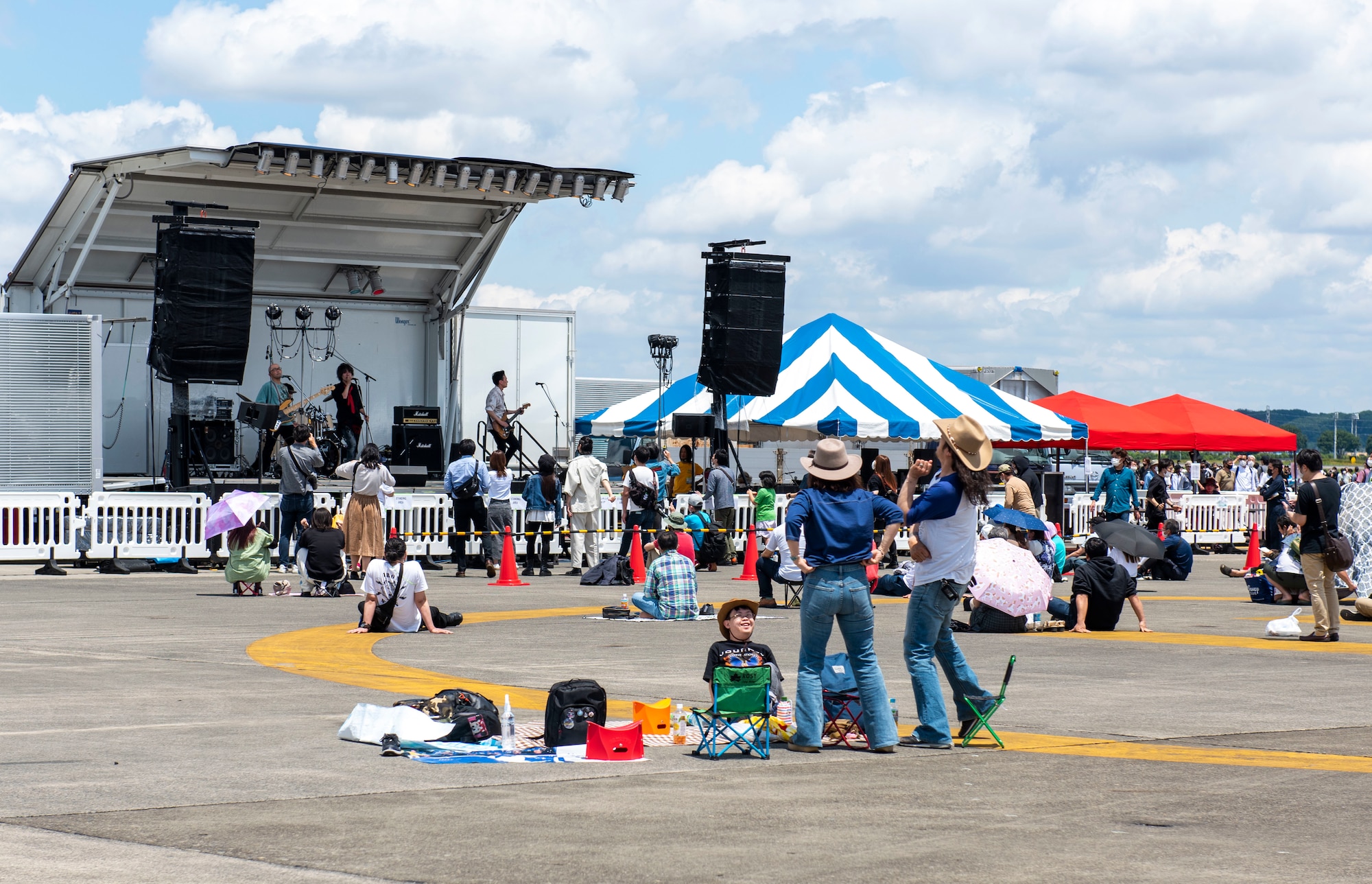 Attendees jam out during Friendship Festival 2022, at Yokota Air Base, Japan May 22, 2022. The two-day festival was an opportunity for visitors to learn more about the U.S. and Japan bilateral partnership, while strengthening the bonds between Yokota and the local communities. Yokota was able to host the event with the support of Japan Self-Defense Force, sister services and the local community. (U.S. Air Force photo by Senior Airman Hannah Bean)
