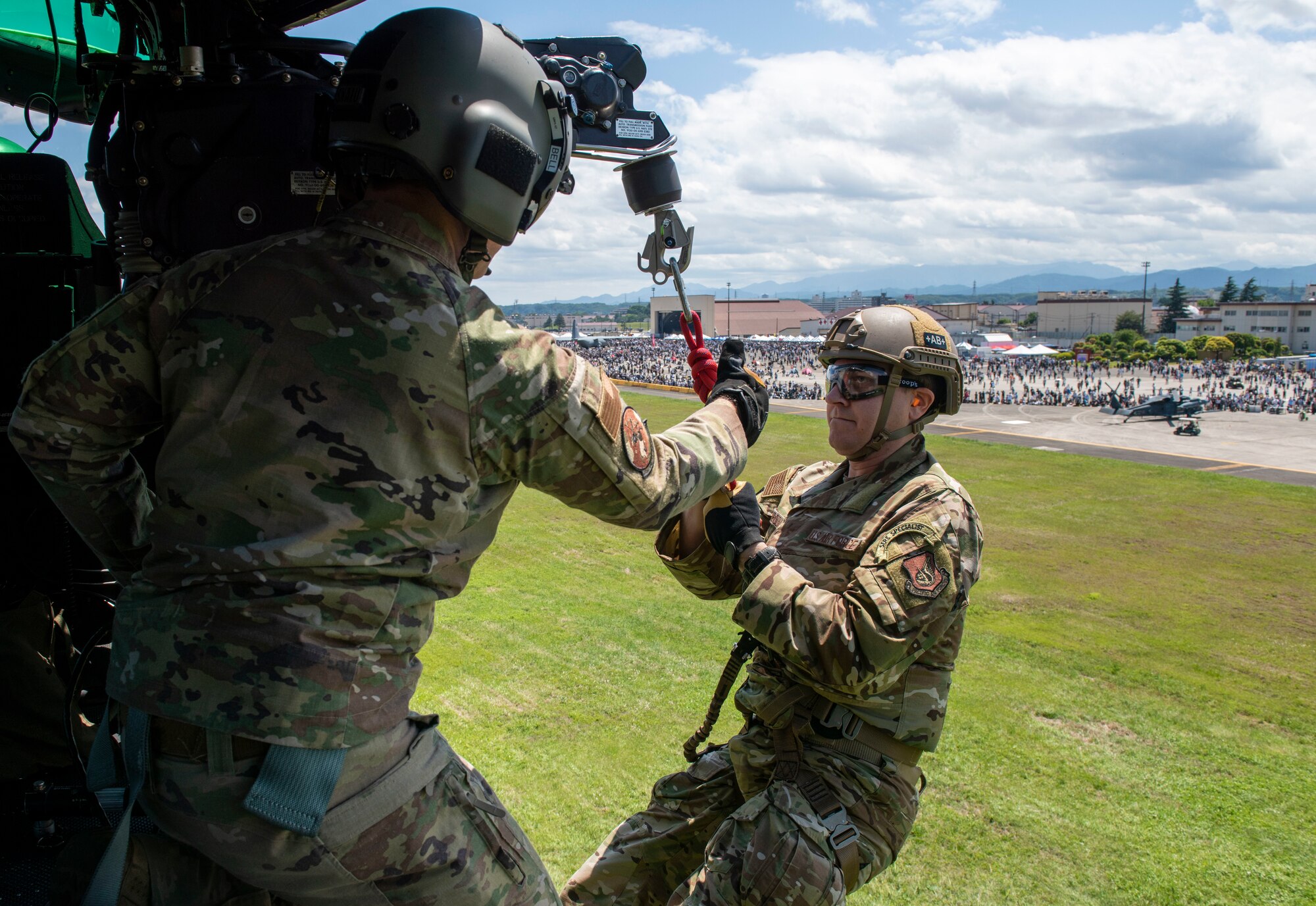 Tech. Sgt. Kevin Bell, 459th Airlift Squadron flight engineer, gives a thumbs up to Tech. Sgt. Mark Rosenboom, 374th Operational Support Squadron Survival Evasion Resistance Escape specialist, during Friendship Festival 2022, at Yokota Air Base, Japan May 22, 2022. The two-day festival was an opportunity for visitors to learn more about the U.S. and Japan bilateral partnership, while strengthening the bonds between Yokota and the local communities. Yokota was able to host the event with the support of Japan Self-Defense Force, sister services and the local community. (U.S. Air Force photo by Senior Airman Hannah Bean)