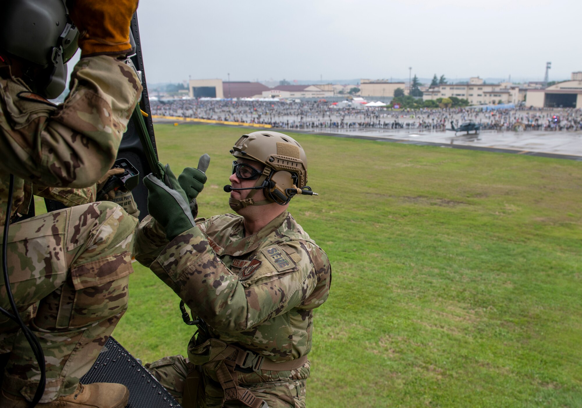 Tech. Sgt. Kyle Yeomans, 374th Operations Support Squadron Survival, Evasion, Resistance & Escape specialist, gives a thumbs up to Tech. Sgt. Zach Webster, 459th Airlift Squadron flight engineer, during Friendship Festival 2022, at Yokota Air Base, Japan May 21, 2022. The two-day festival was an opportunity for visitors to learn more about the U.S. and Japan bilateral partnership, while strengthening the bonds between Yokota and the local communities. Yokota was able to host the event with the support of Japan Self-Defense Force, sister services and the local community. (U.S. Air Force photo by Senior Airman Hannah Bean)