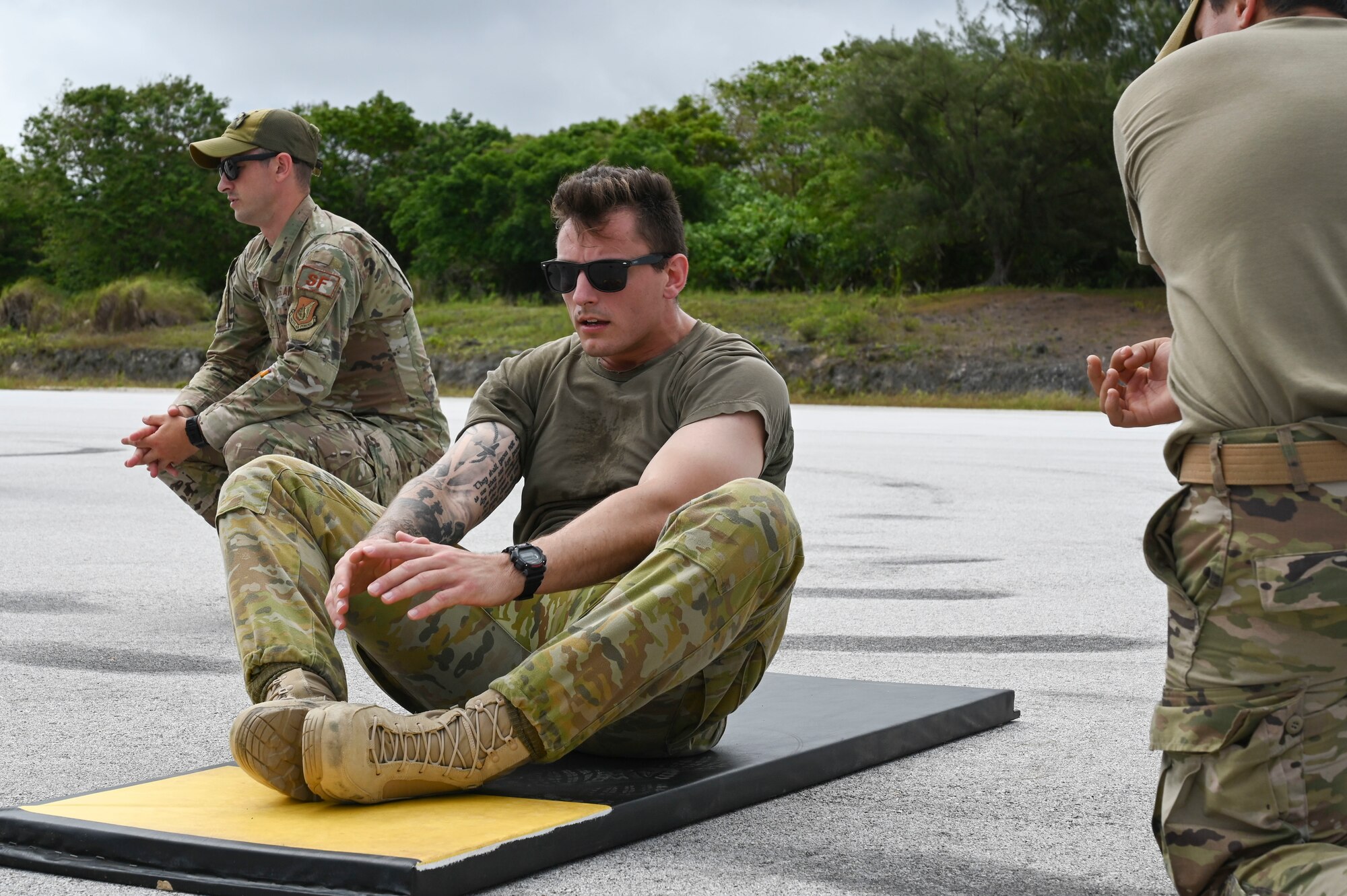 Royal Australian Air Force Corporal Daniel Cafaro, 1st Security Forces Squadron performs butterfly sit-ups during the Advanced Combat Skills Assessment at Andersen Air Force Base, Guam, April 16, 2022. ACSA is a week-long competition that showcases the combat capability of security forces as a human weapon system. (U.S. Air Force photo by Airman 1st Class Emily Saxton)