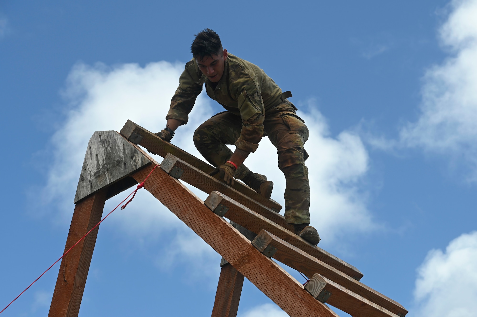 U.S. Air Force Airman 1st Class Turner Yates, installation entry controller assigned to the 647th Security Forces Squadron, Joint Base Pearl Harbor-Hickam, Hawaii, climbs down an obstacle during the Advanced Combat Skills Assessment at Andersen Air Force Base, Guam, April 17, 2022. ACSA bolsters defender ethos, strengthens esprit-de-corps amongst participants and reinforces the competitive nature within security forces. (U.S. Air Force photo by Airman 1st Class Emily Saxton)